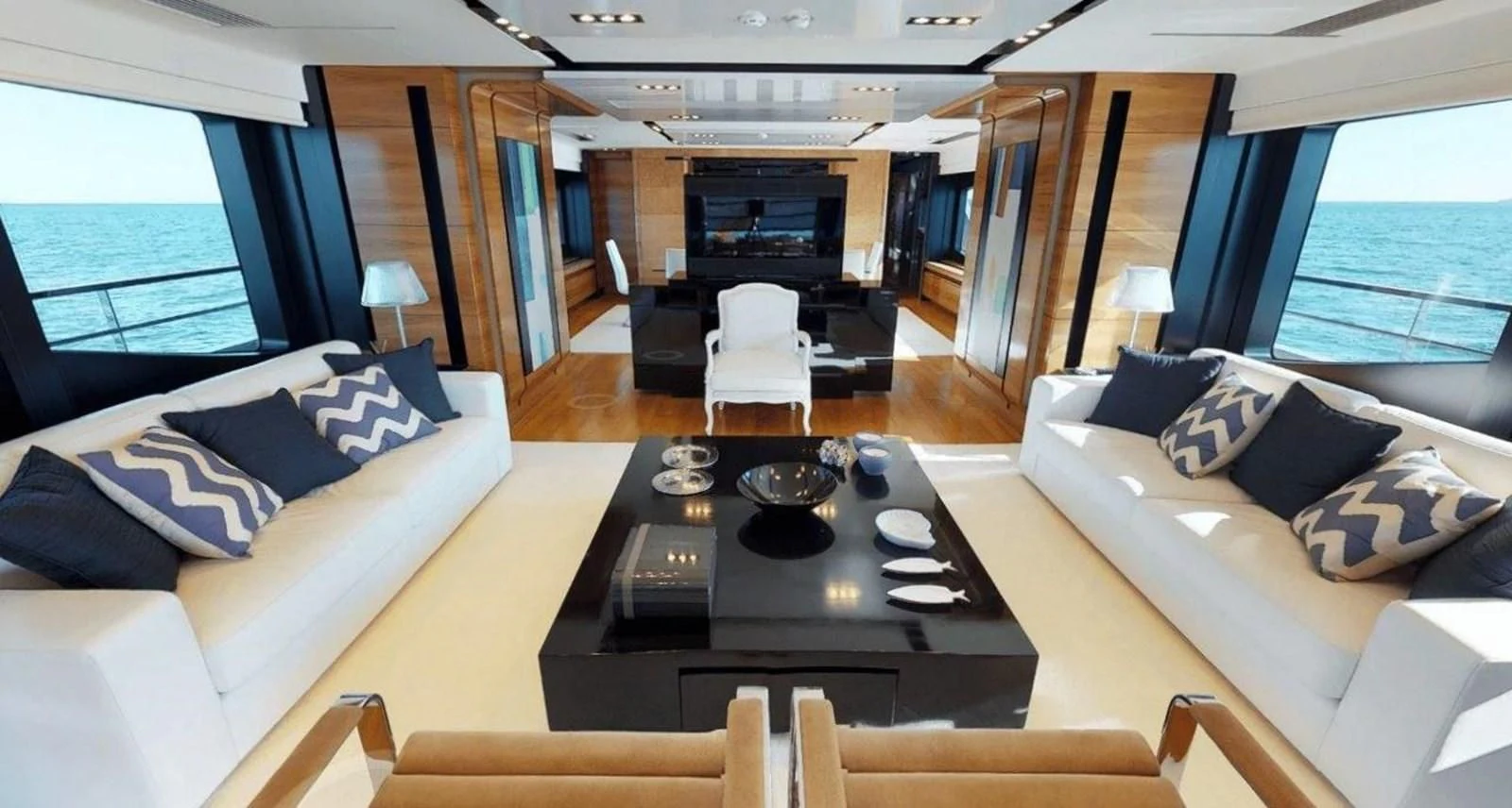 a living room with a couch and a coffee table aboard FUSION Yacht for Charter