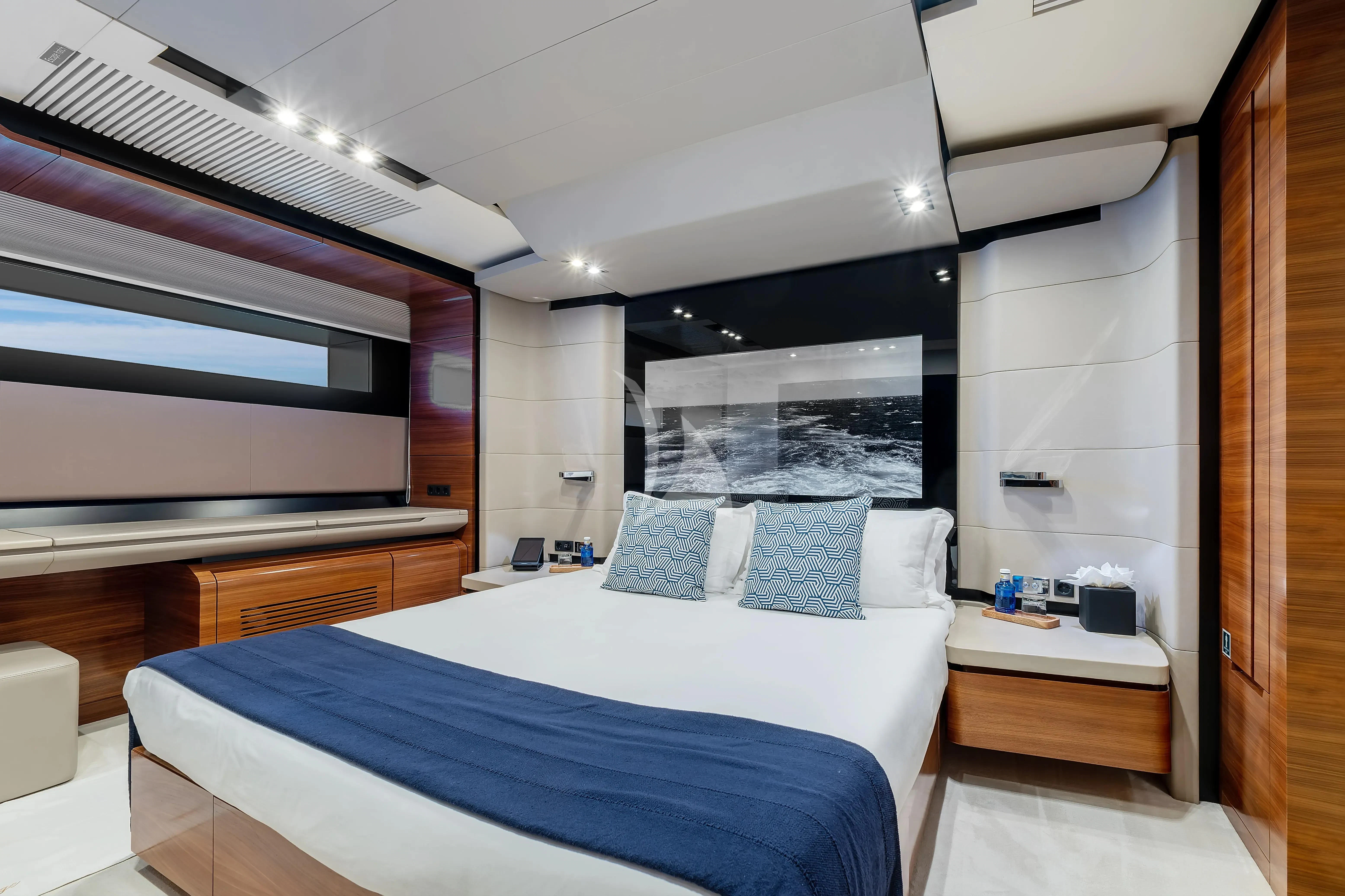a room with a bed and a mirror aboard FUSION Yacht for Charter