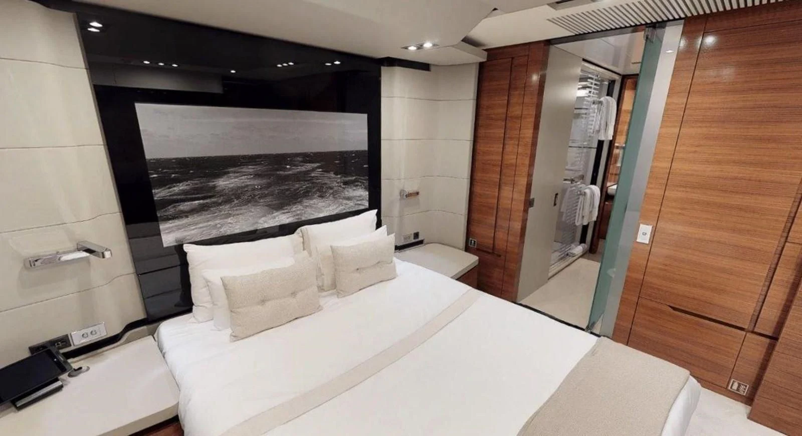 a room with a bed and a television aboard FUSION Yacht for Charter