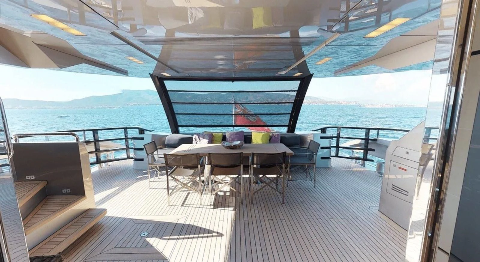a deck with a table and chairs aboard FUSION Yacht for Charter