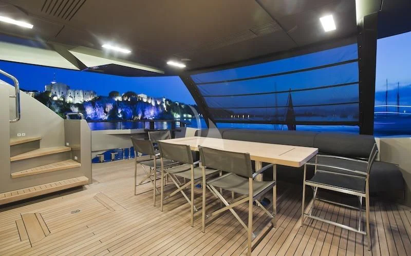 a room with a table and chairs aboard FUSION Yacht for Charter