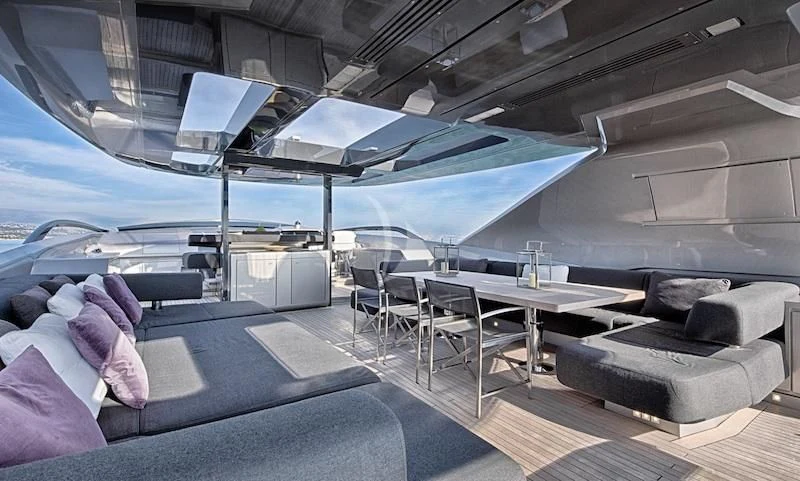 a room with a couch and a table and a laptop on the table aboard FUSION Yacht for Charter