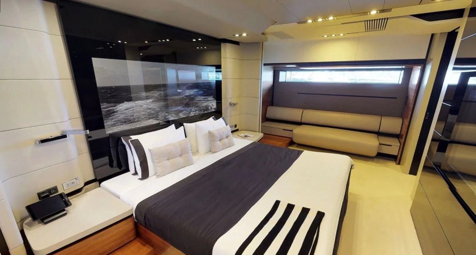 a room with a bed and a tv aboard FUSION Yacht for Charter