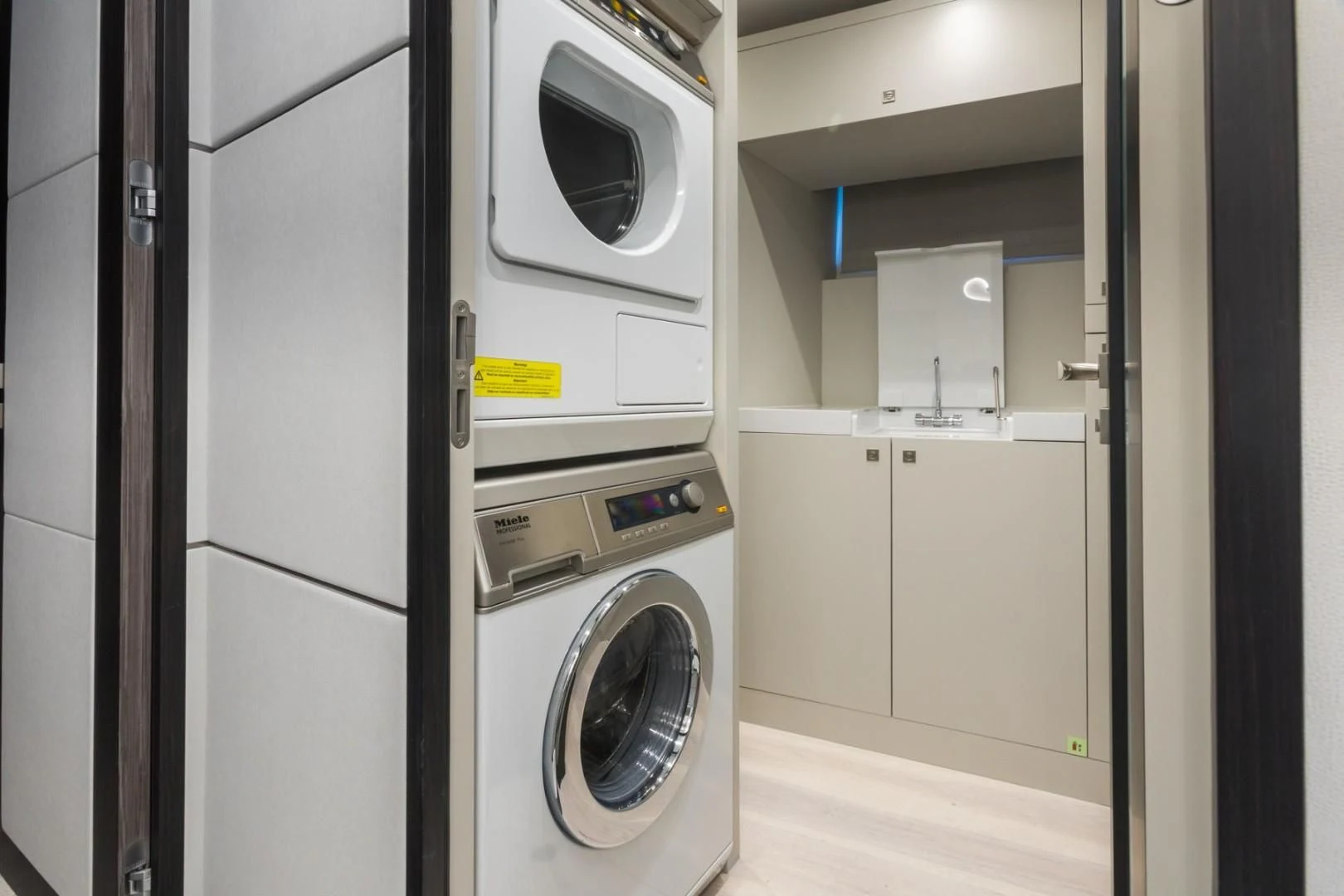 a laundry room with washing machines aboard GG Yacht for Sale