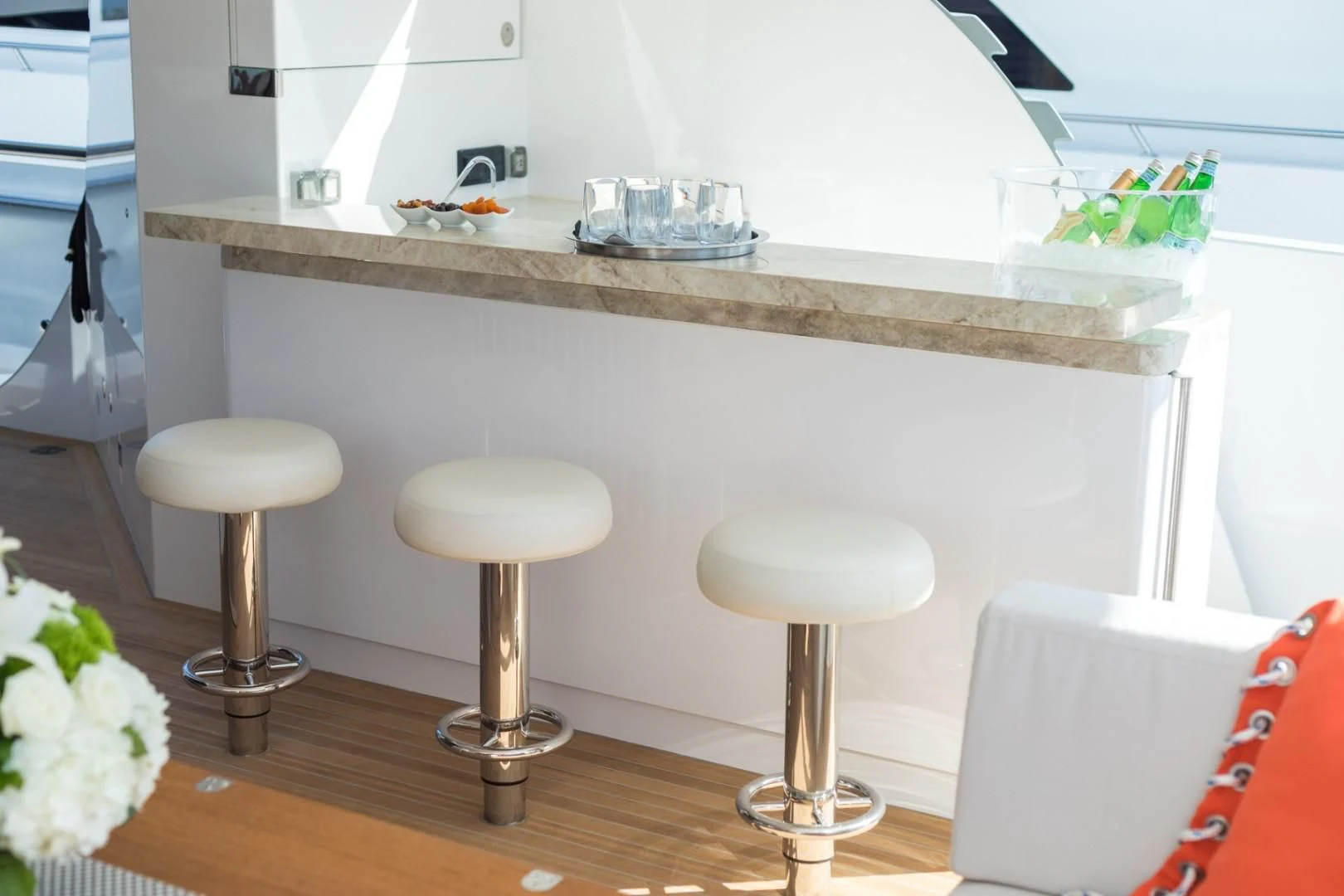 a white kitchen with stools aboard GG Yacht for Sale
