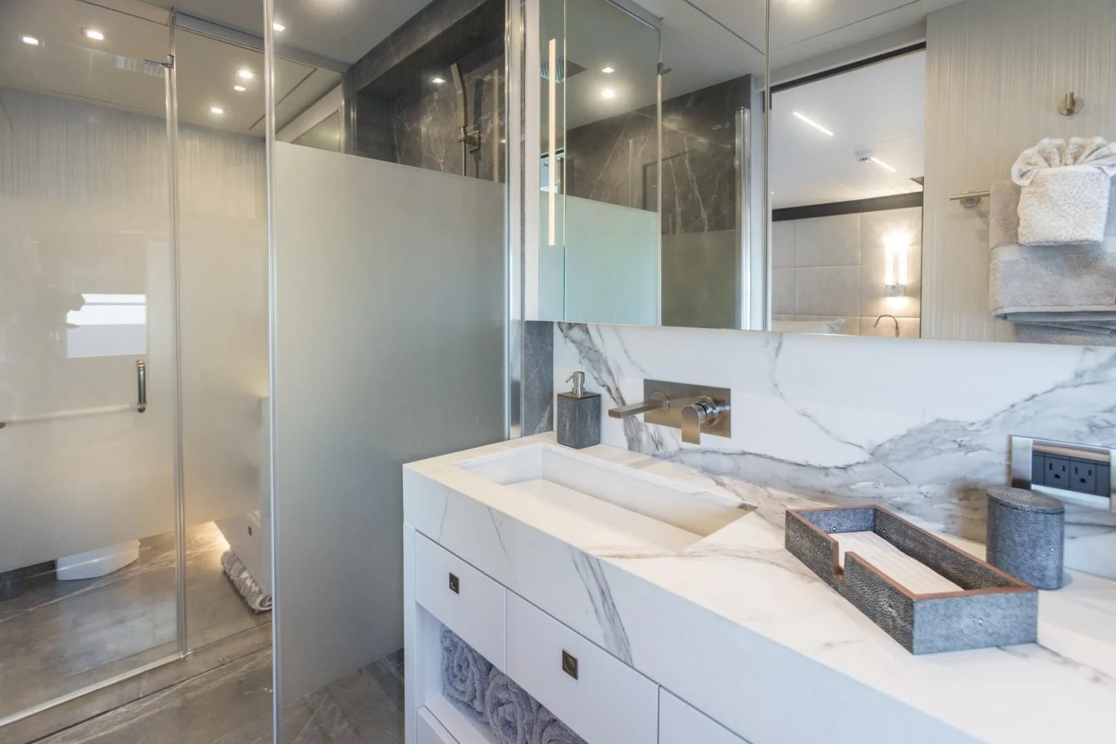 a bathroom with a large mirror aboard GG Yacht for Sale