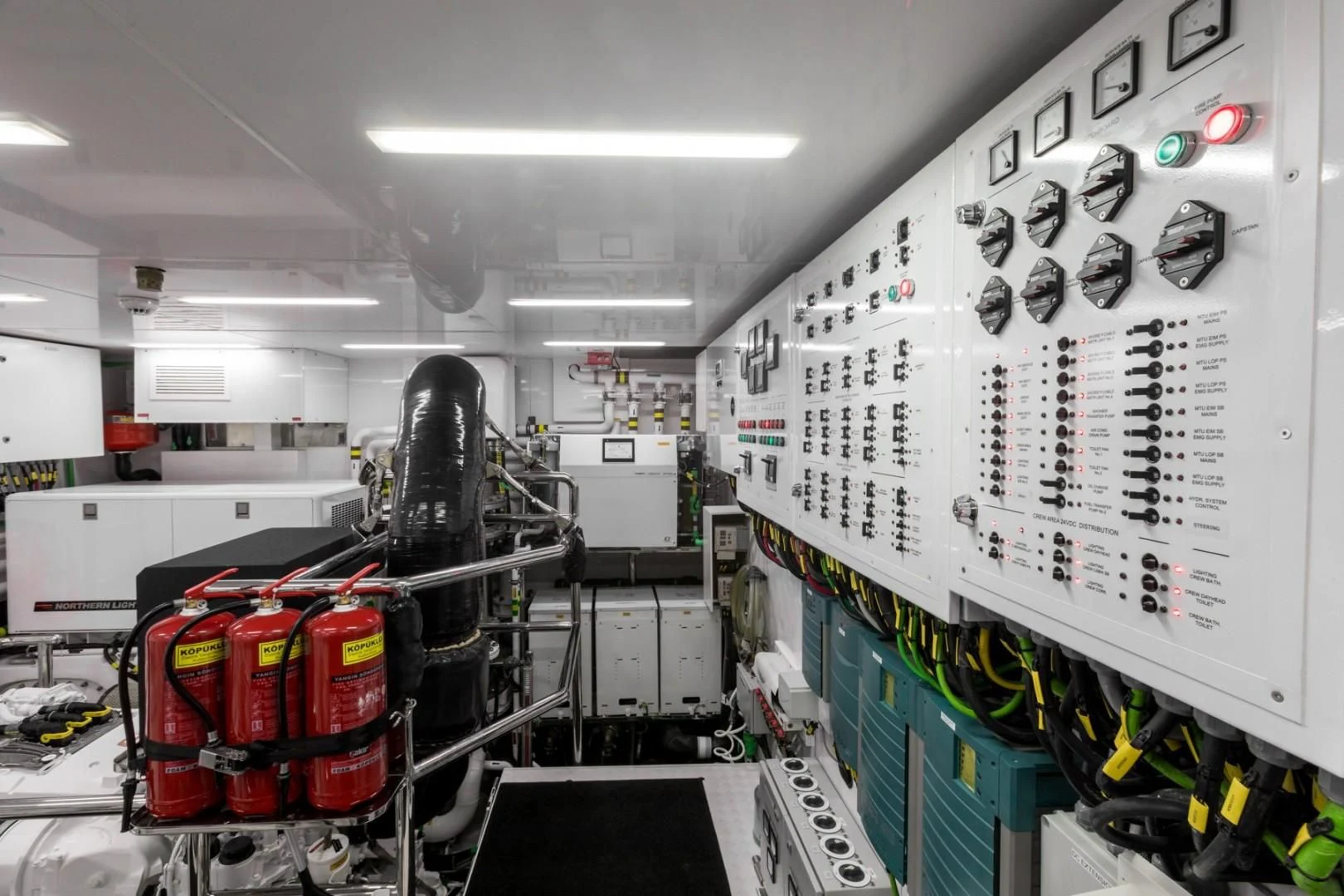 a room with a large display of electronics and wires aboard GG Yacht for Sale