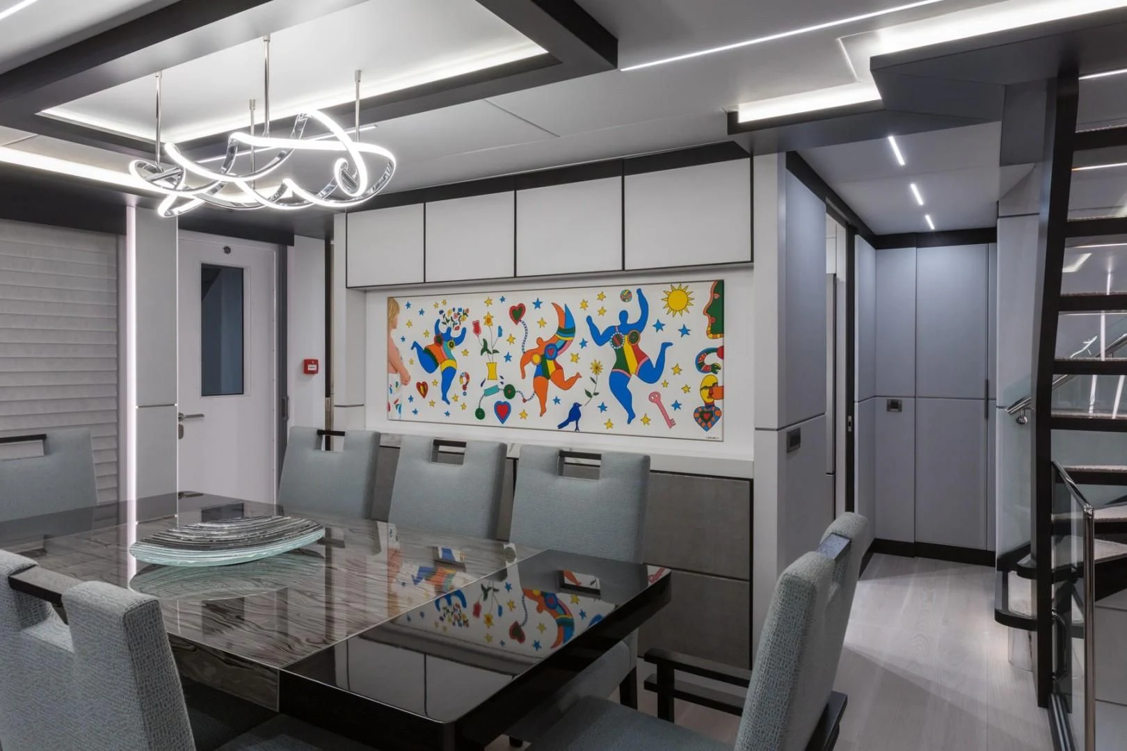 a room with a table and chairs aboard GG Yacht for Sale