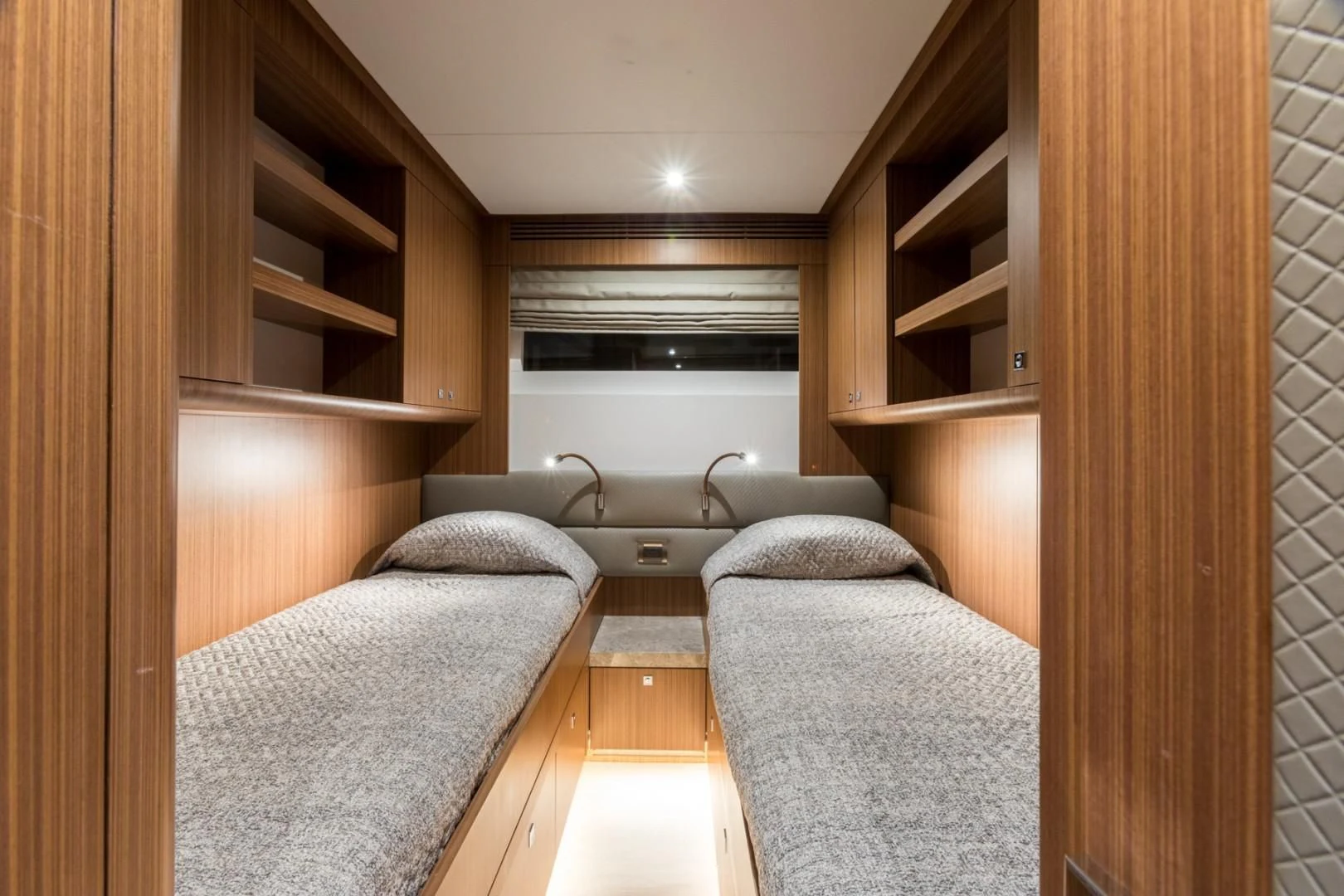 a bedroom with a bed and a bookcase aboard GG Yacht for Sale
