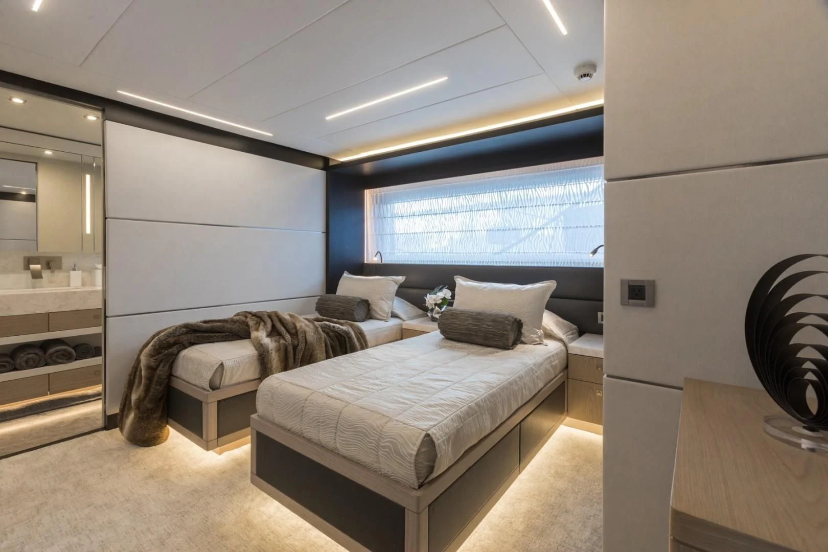 a room with a bed and a large window aboard GG Yacht for Sale