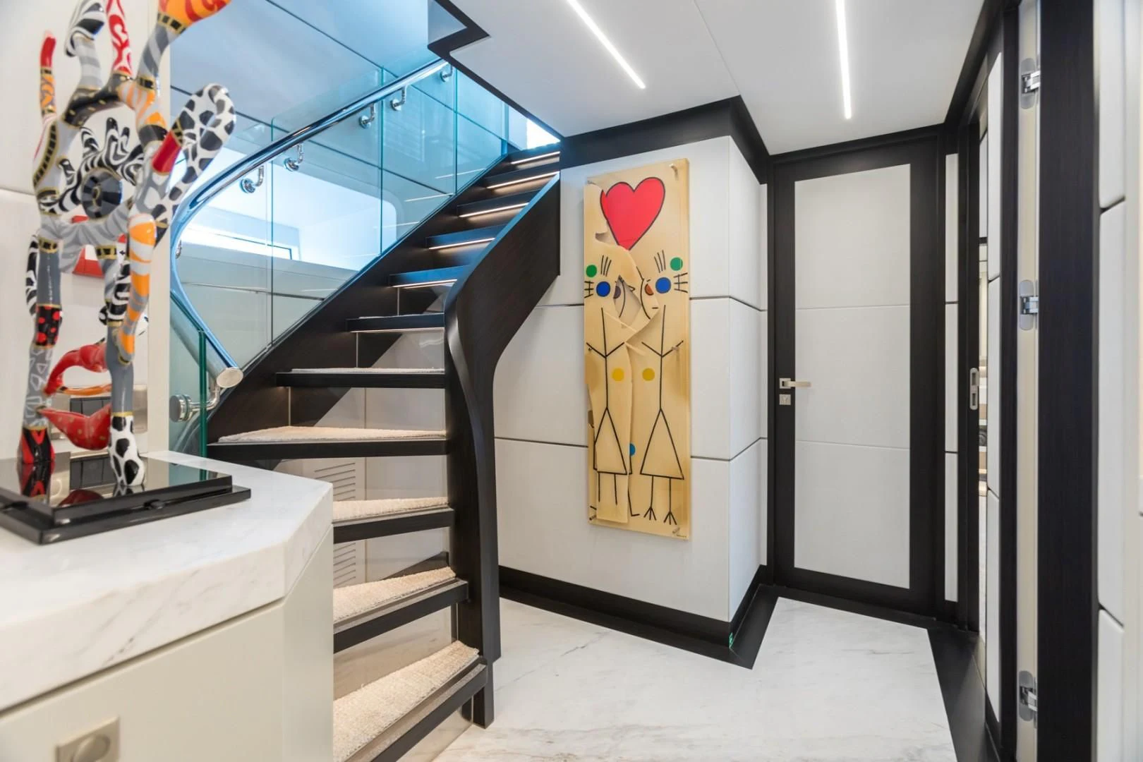 a hallway with a painting on the wall aboard GG Yacht for Sale