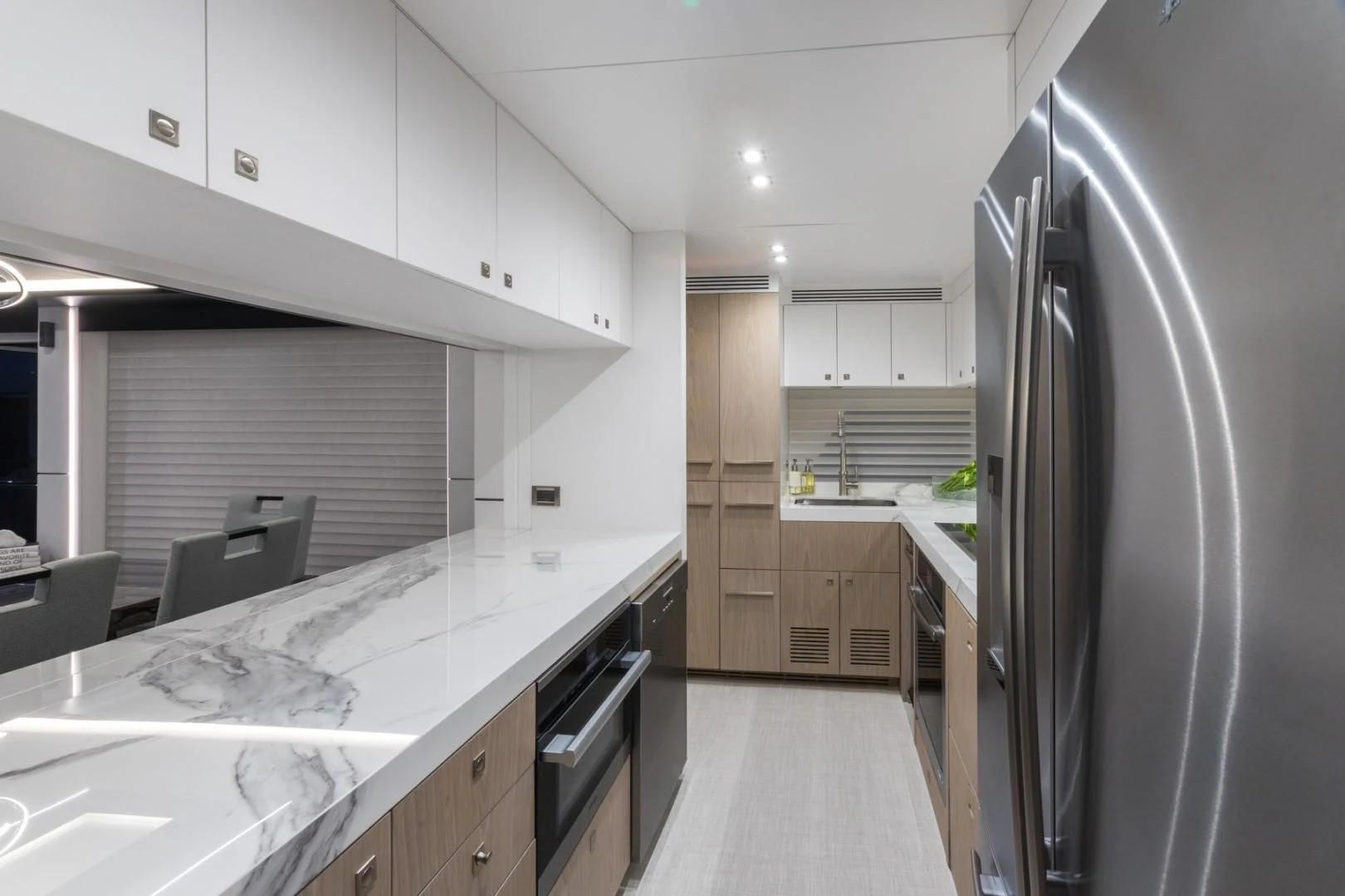 a kitchen with a fridge and a table aboard GG Yacht for Sale