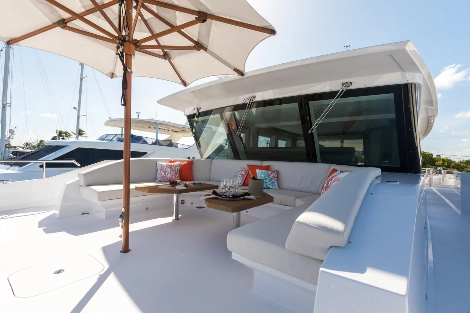 a lounge area with a lounge chair and umbrella aboard GG Yacht for Sale