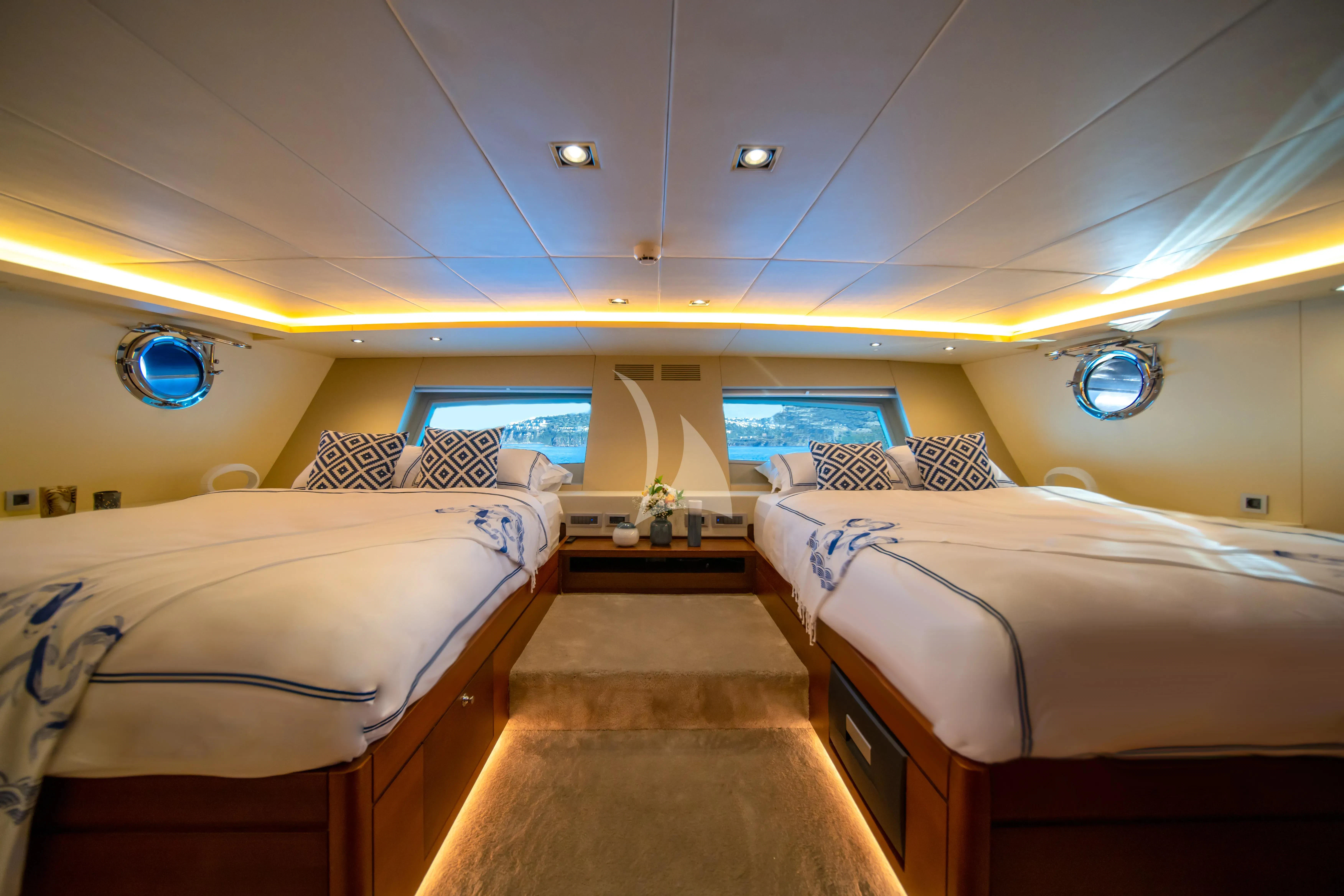 a room with beds and a tv aboard DOUBLE EAGLE Yacht for Sale