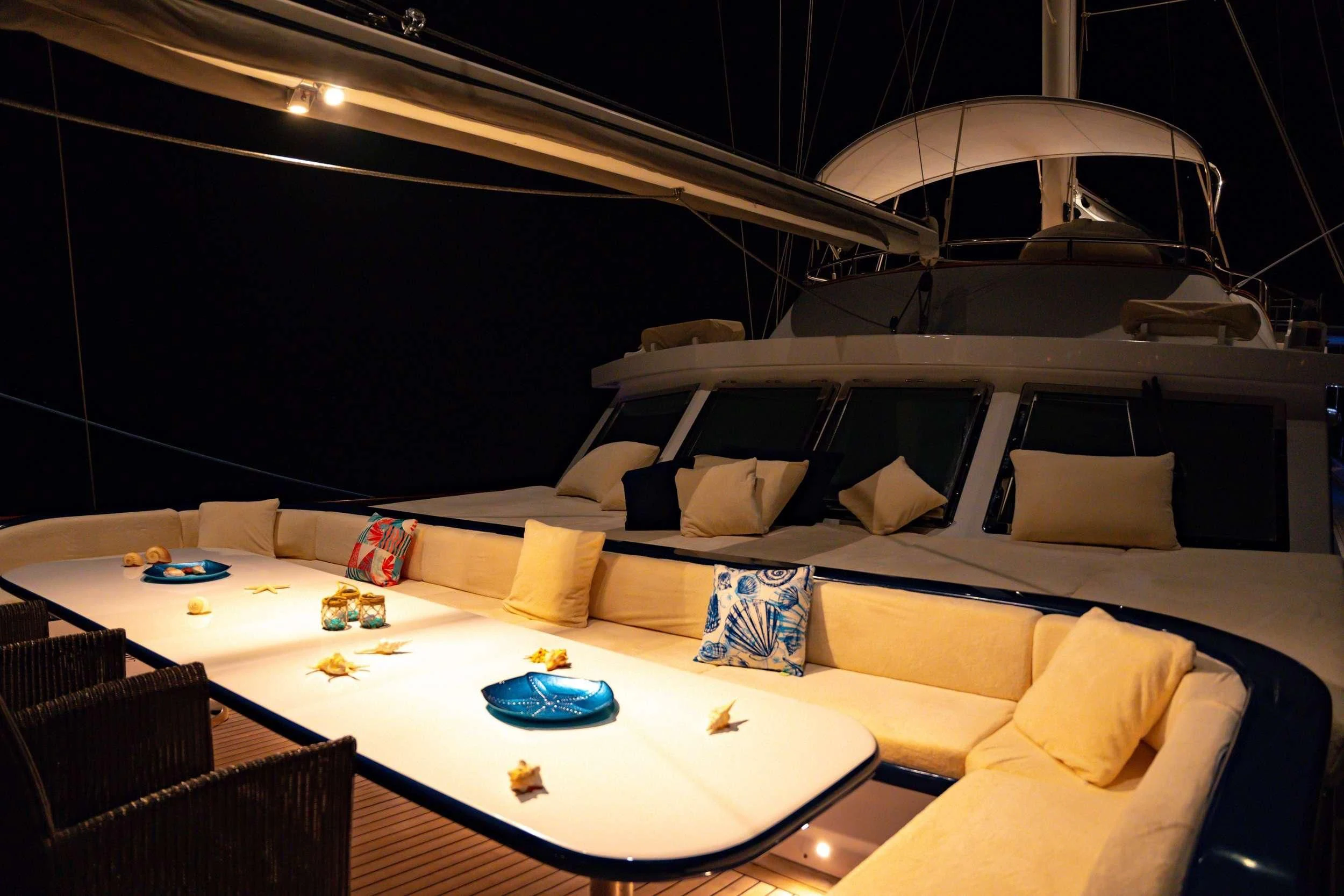 a room with a bed and a table with a white tablecloth aboard DOUBLE EAGLE Yacht for Sale
