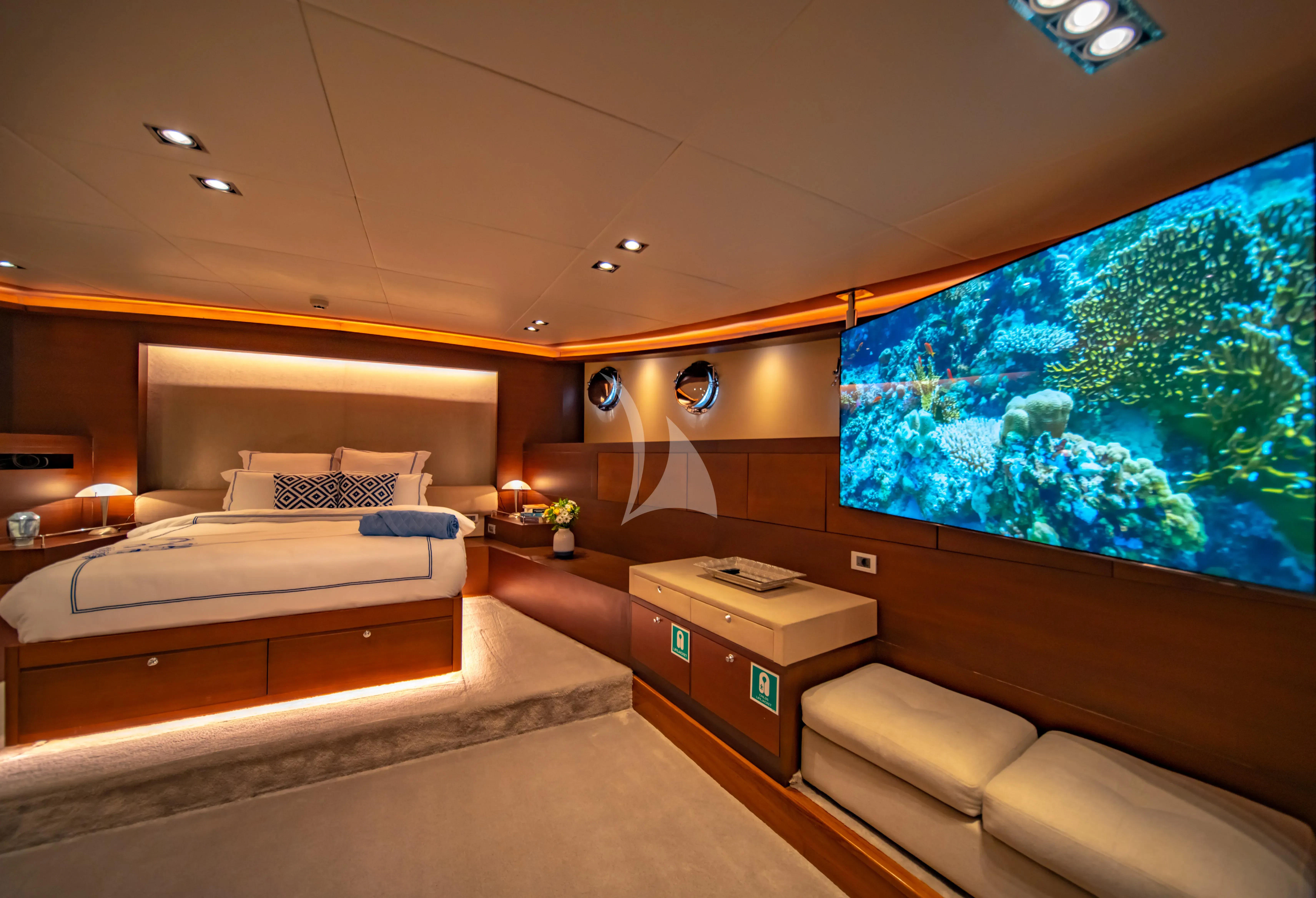 a room with a large window and a bed and a large fish tank aboard DOUBLE EAGLE Yacht for Sale