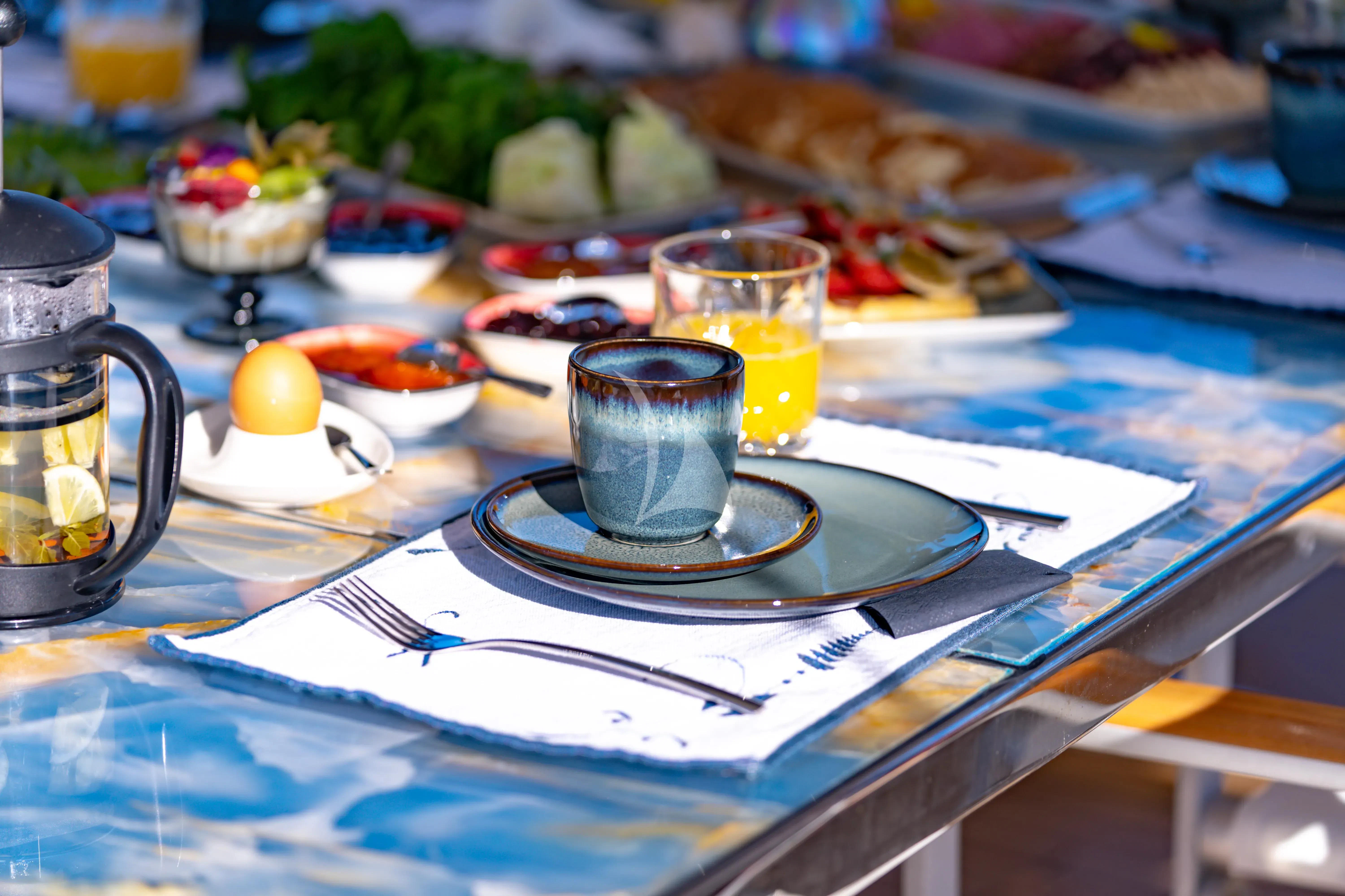 a table with plates and glasses aboard DOUBLE EAGLE Yacht for Sale