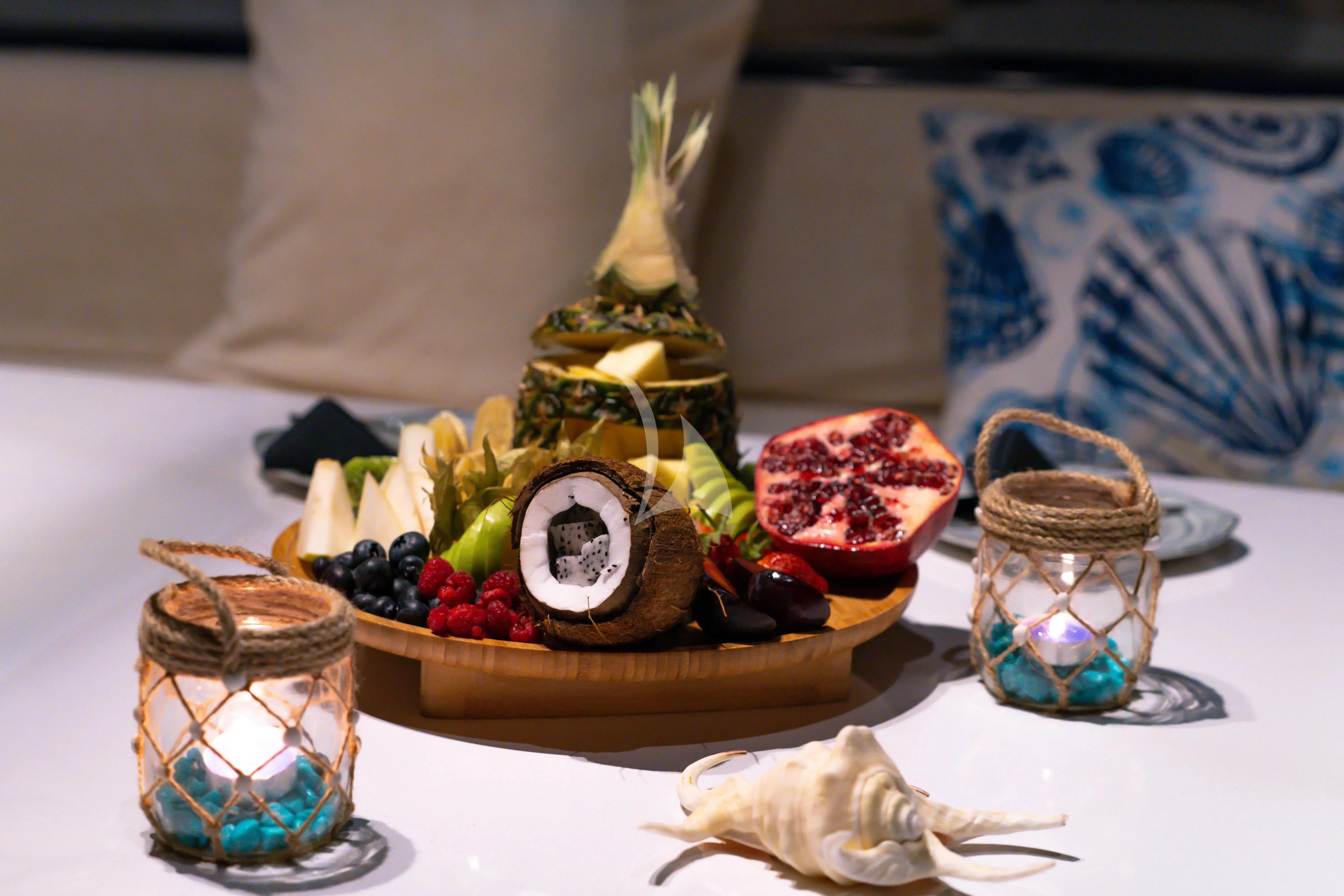 a table with a vase and food on it aboard DOUBLE EAGLE Yacht for Sale