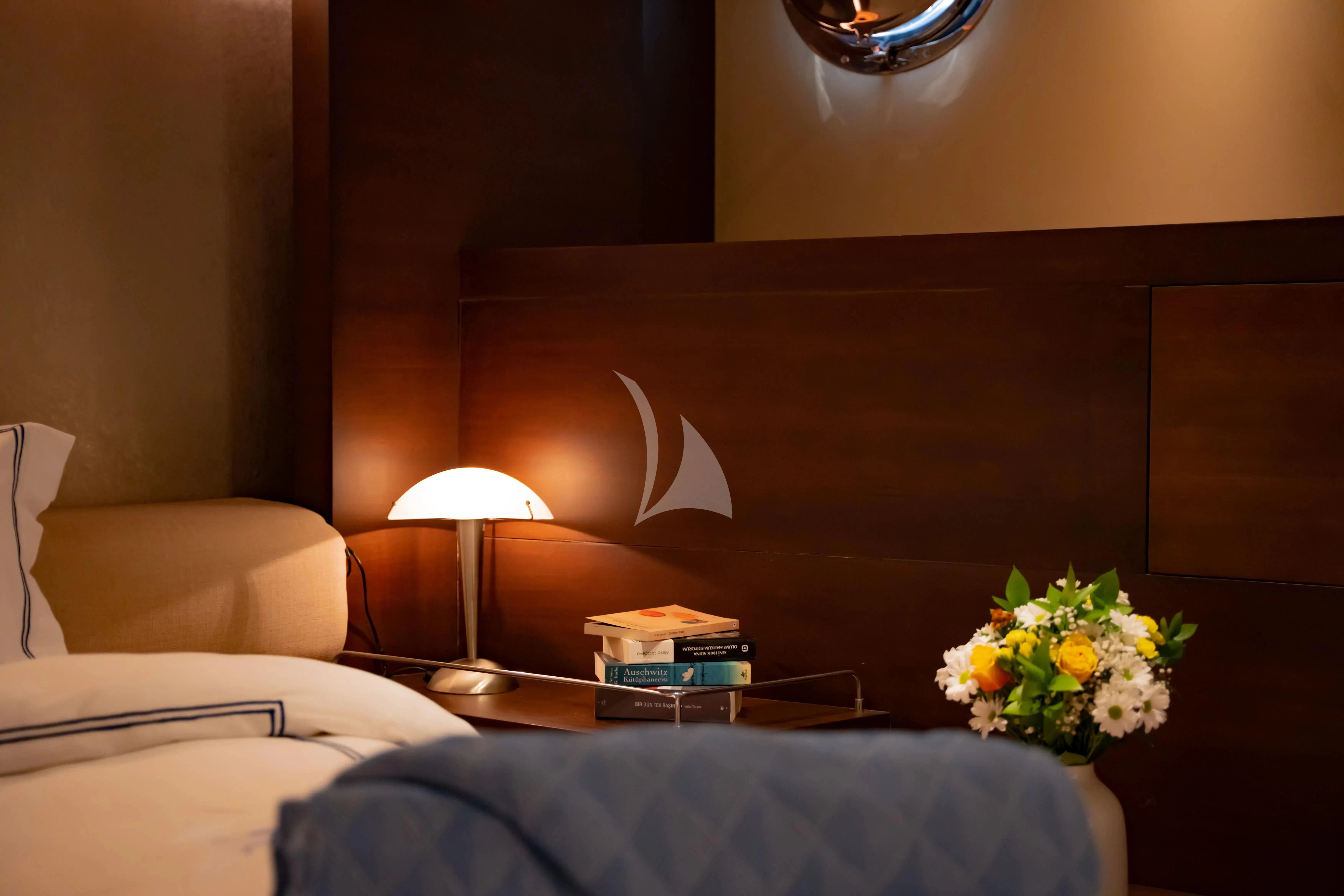 a hotel room with a bed and flowers aboard DOUBLE EAGLE Yacht for Sale