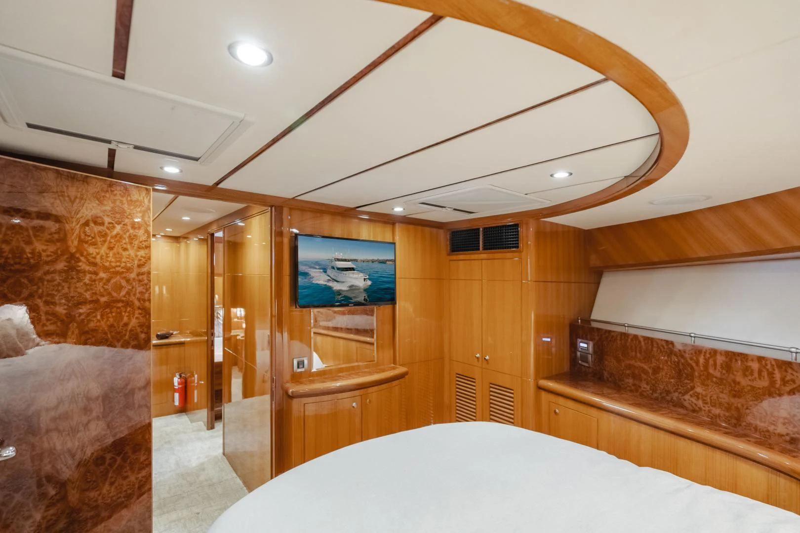 a room with a bed and a television aboard OBSESSION Yacht for Sale