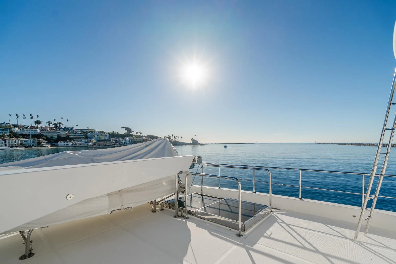 a view of a beach from a balcony aboard OBSESSION Yacht for Sale