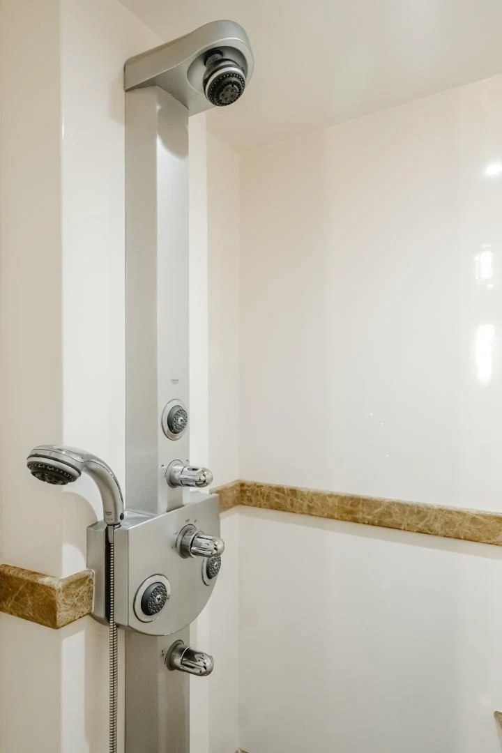 a shower with a wooden handle aboard OBSESSION Yacht for Sale