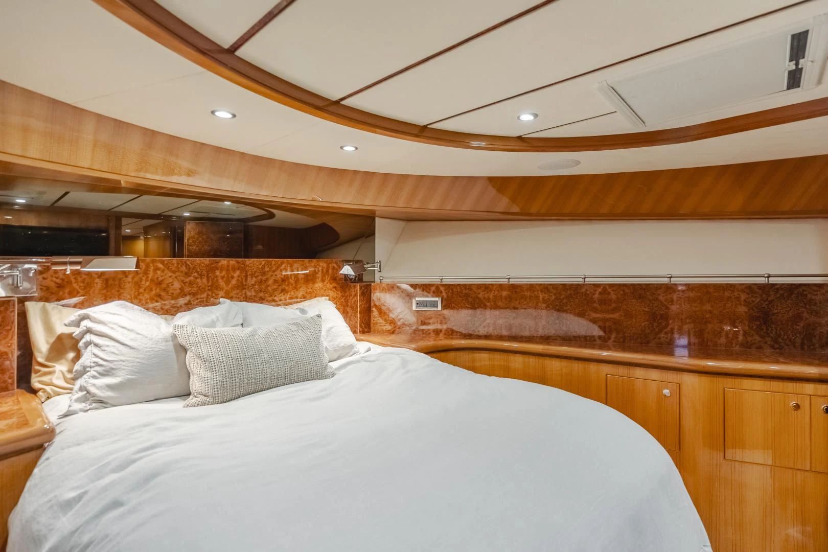 a room with a bed and a wood wall aboard OBSESSION Yacht for Sale