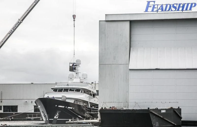 a boat docked next to a building aboard VALORIA B Yacht for Sale