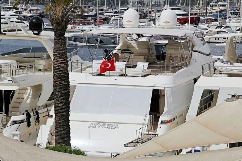 a white building with a red sign aboard HAPPY 2 Yacht for Sale
