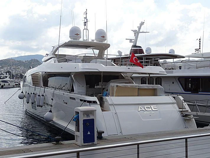 a large white boat with a red stripe on the front aboard HAPPY 2 Yacht for Sale
