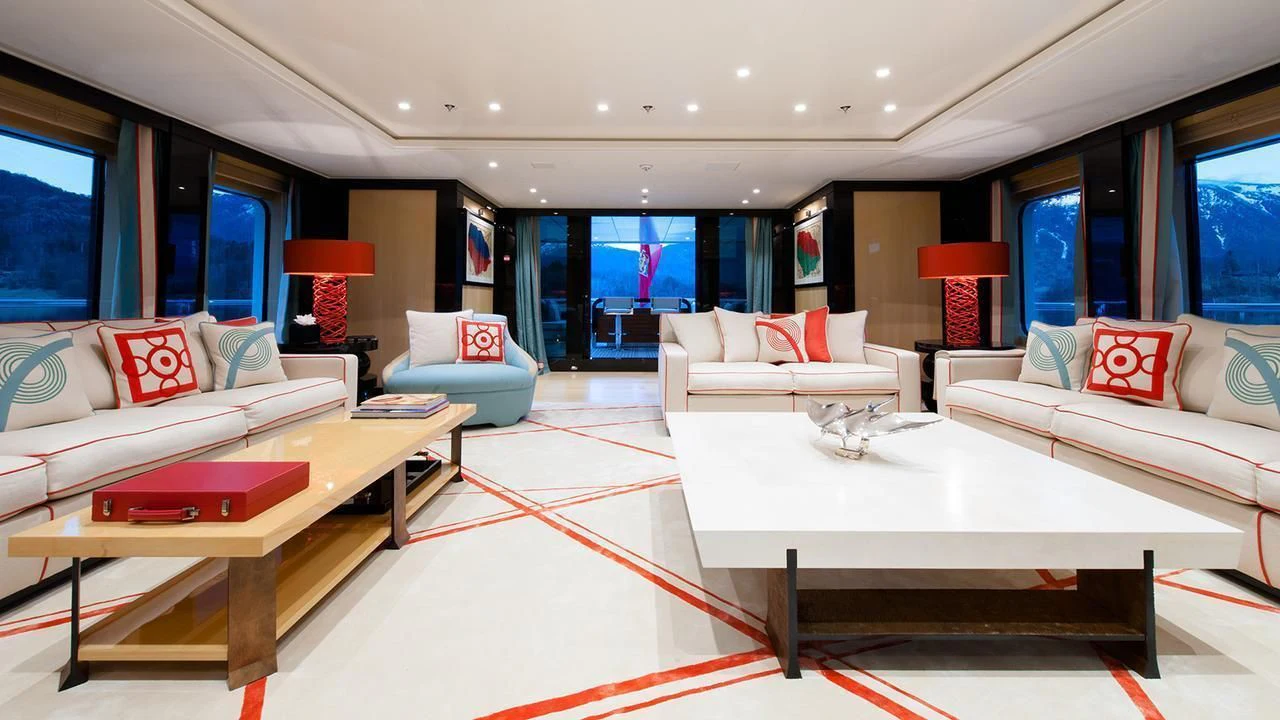 a living room with a table and couches aboard EVENT Yacht for Sale