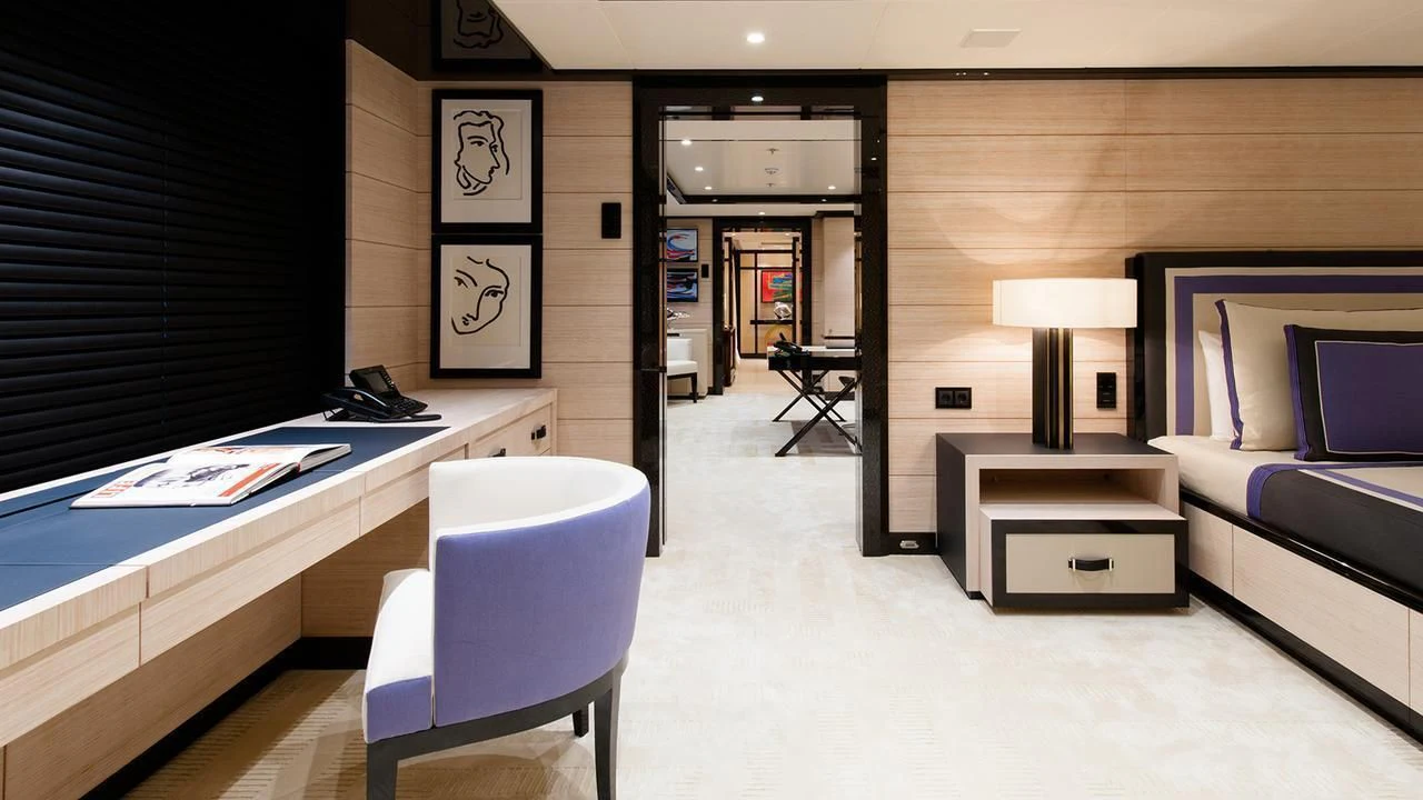 a room with a desk and a bed aboard EVENT Yacht for Sale