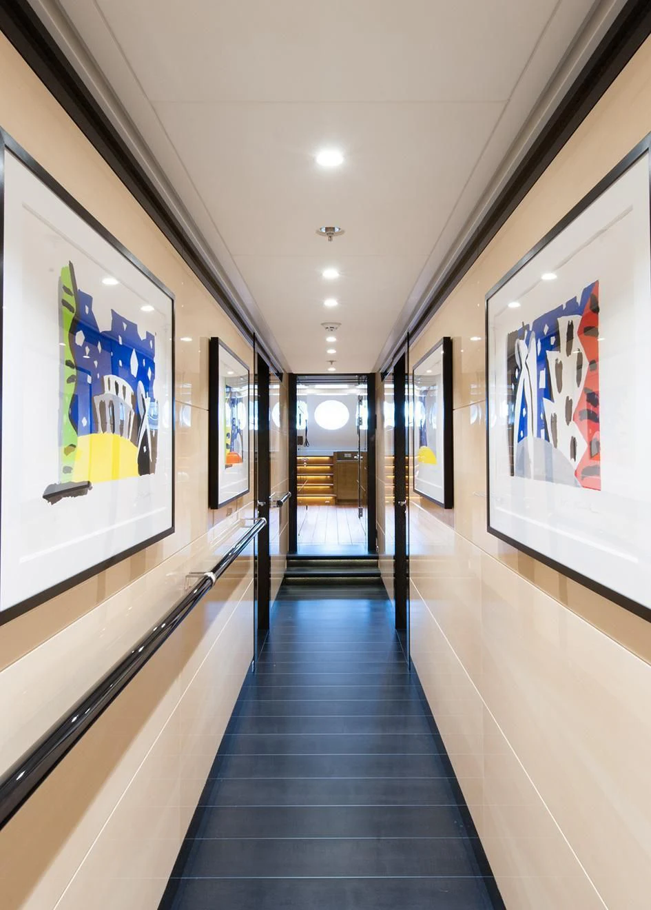 a hallway with art on the wall aboard EVENT Yacht for Sale