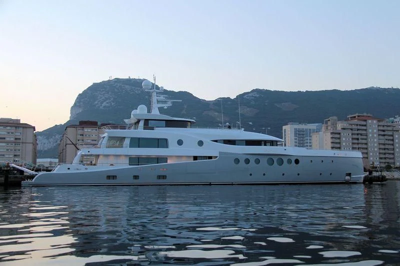 a large white boat in a harbor aboard EVENT Yacht for Sale