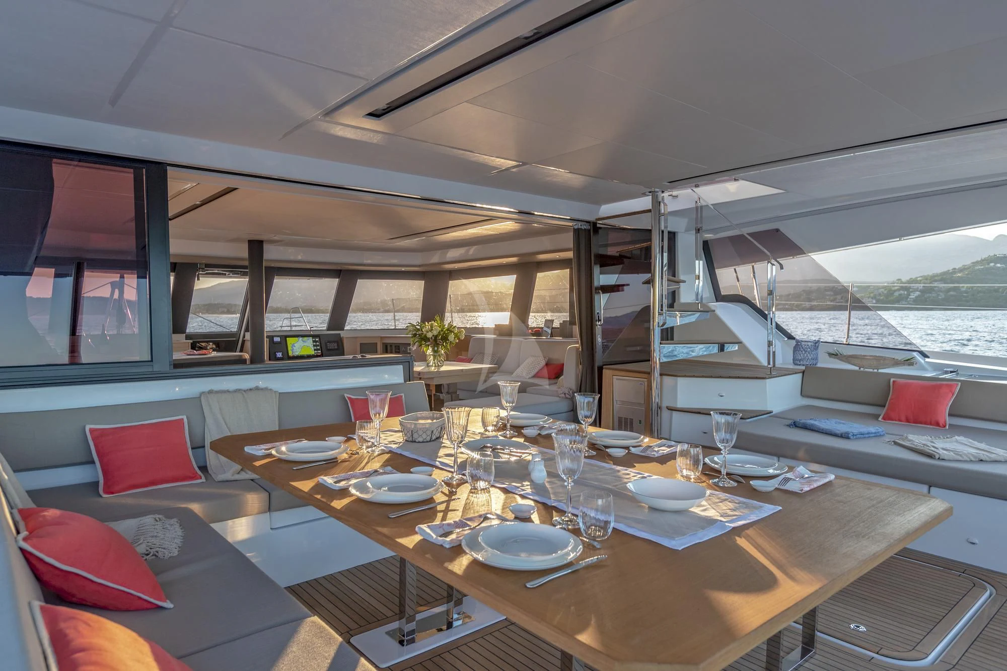 a table with plates and glasses on it aboard AETHER Yacht for Charter