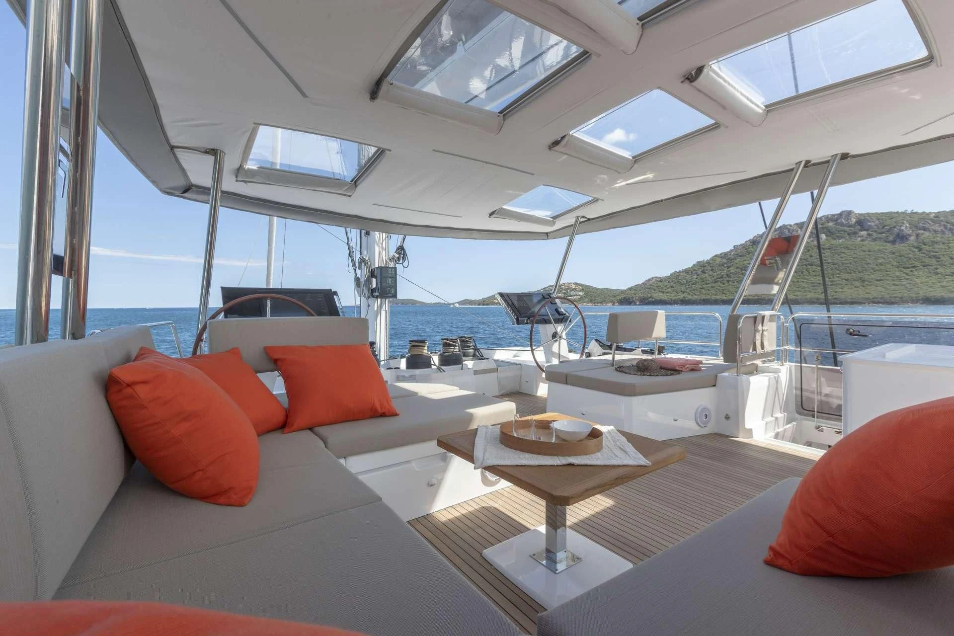 a boat with pillows and a table aboard AETHER Yacht for Charter