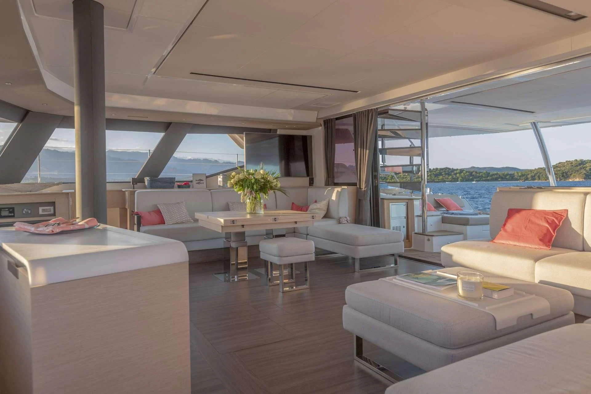 a room with a couch and a table and a window aboard AETHER Yacht for Charter