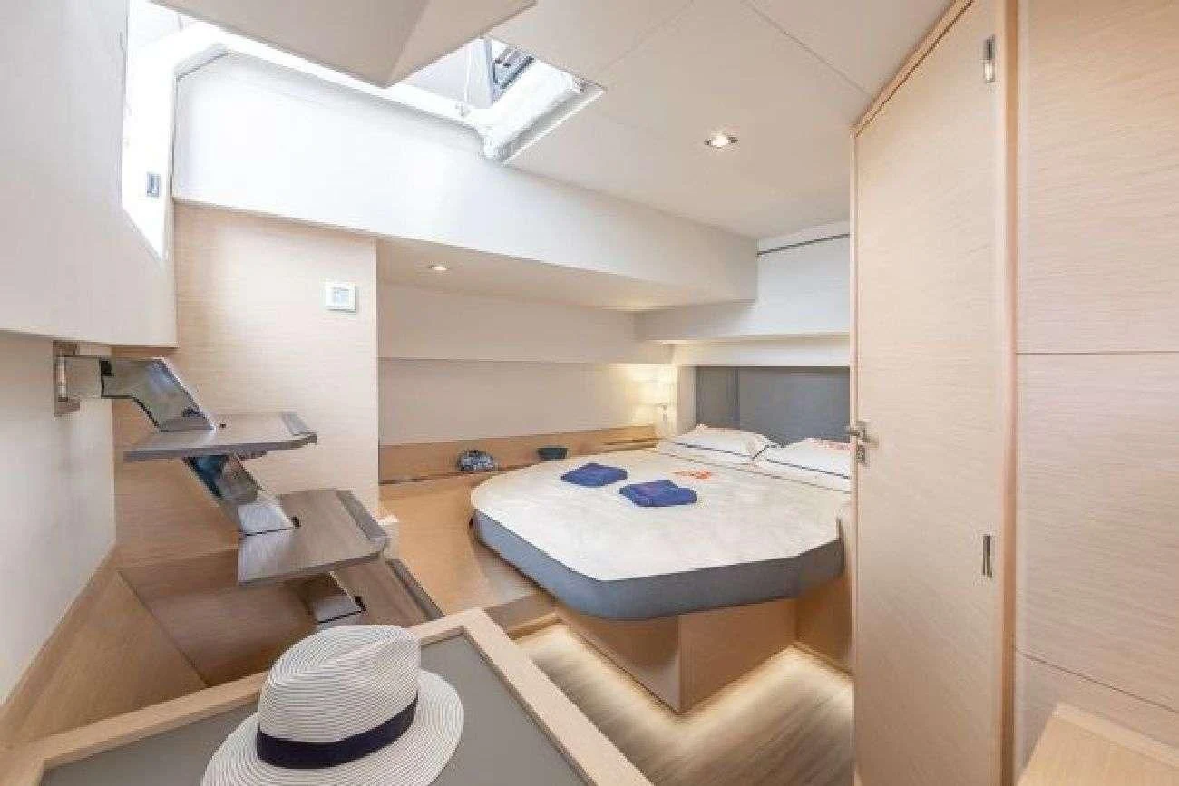 a room with a bed and a hat aboard AETHER Yacht for Charter