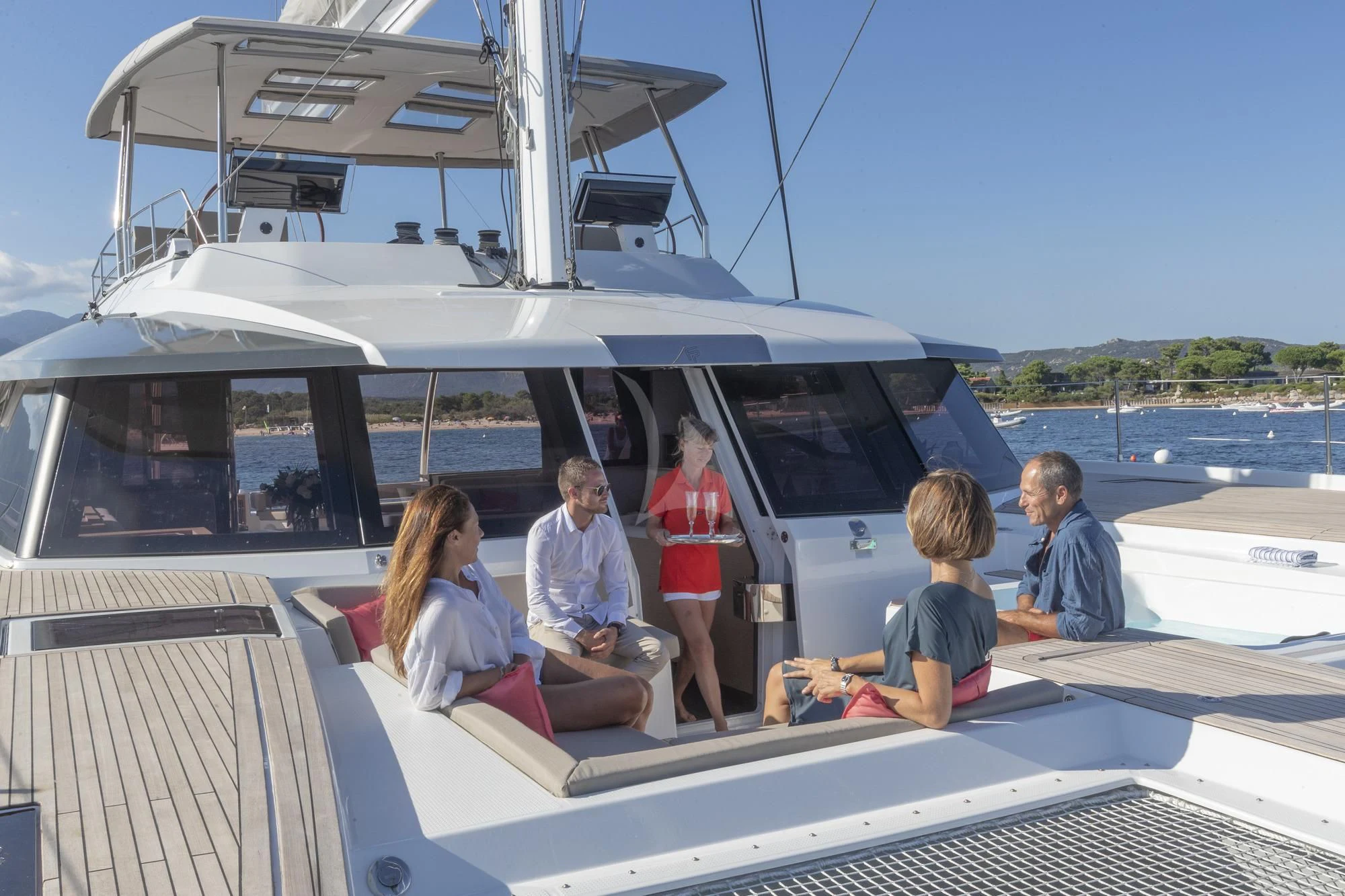 a group of people sitting on a boat aboard AETHER Yacht for Charter