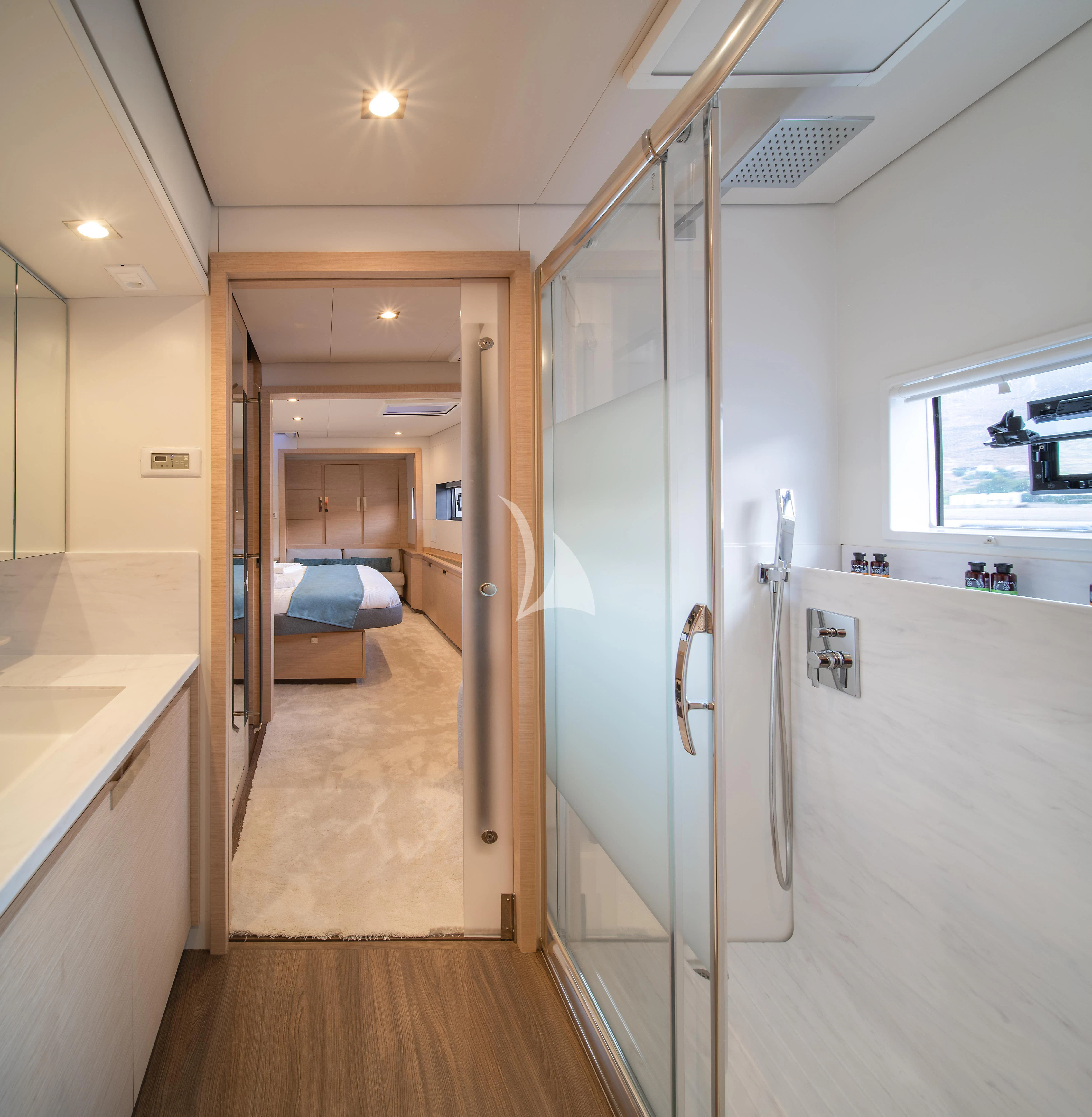 a long hallway with a bed and a door aboard AETHER Yacht for Charter