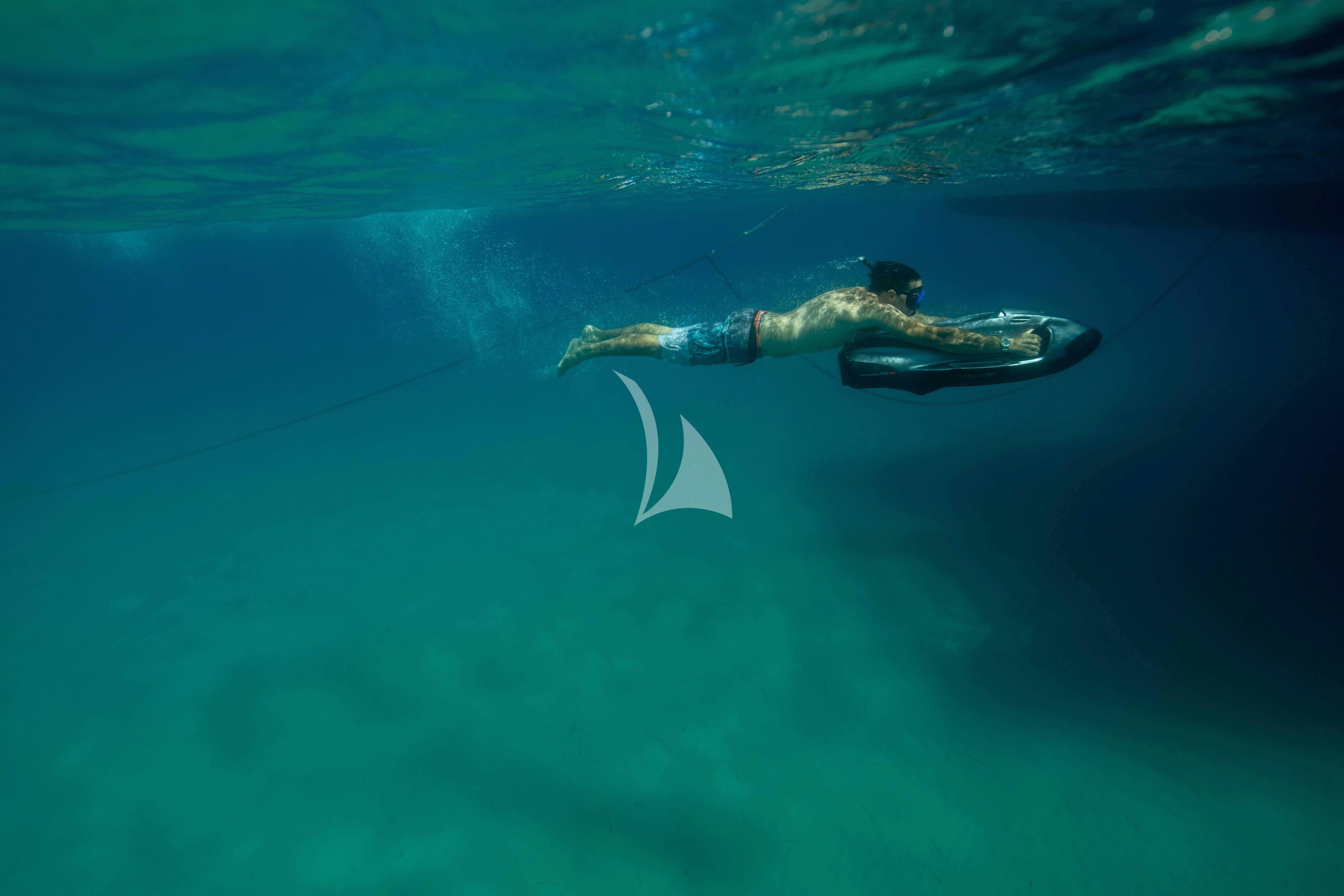a person swimming underwater aboard AETHER Yacht for Charter