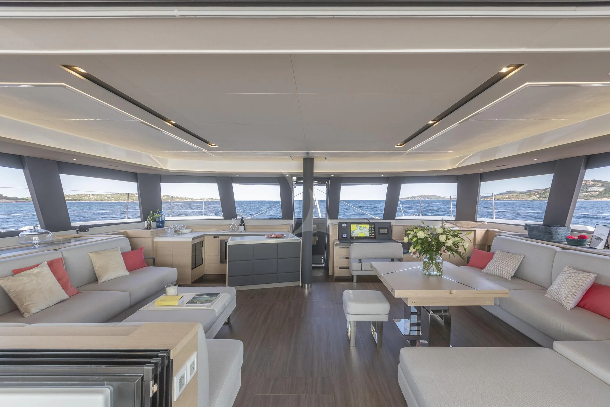 a room with a couch and a table and a window aboard AETHER Yacht for Charter