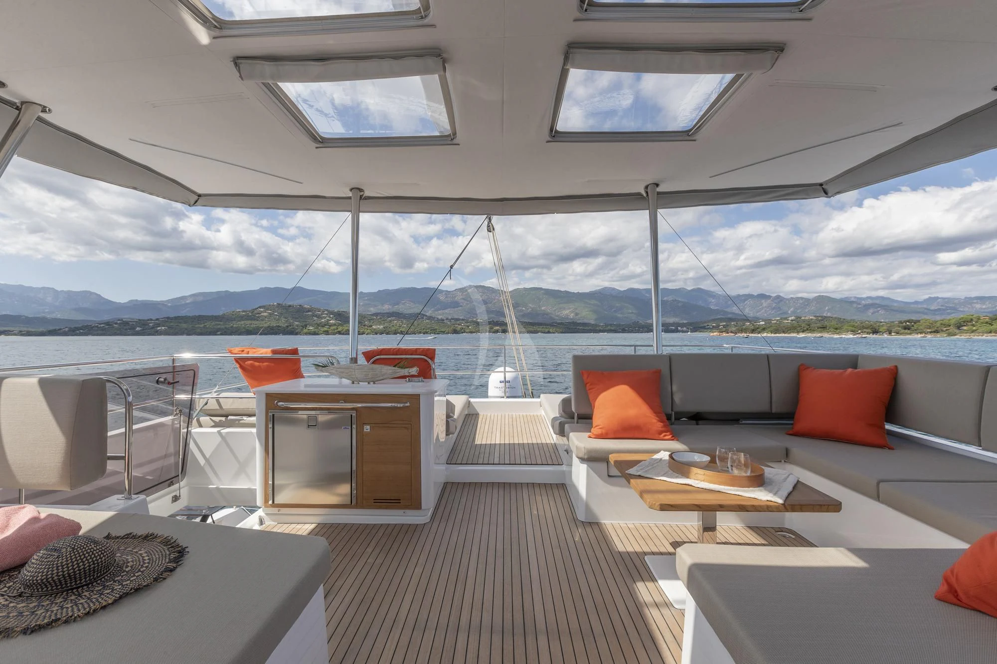 a room with a couch and a table and chairs aboard AETHER Yacht for Charter