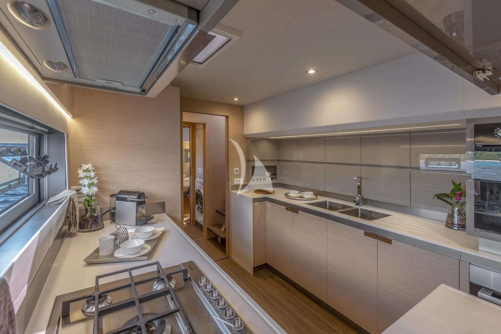 a kitchen with a countertop sink and cabinets aboard AETHER Yacht for Charter