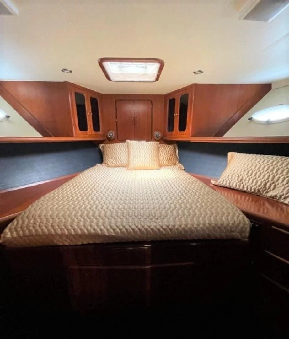 a bed in a room aboard MR. ED Yacht for Sale
