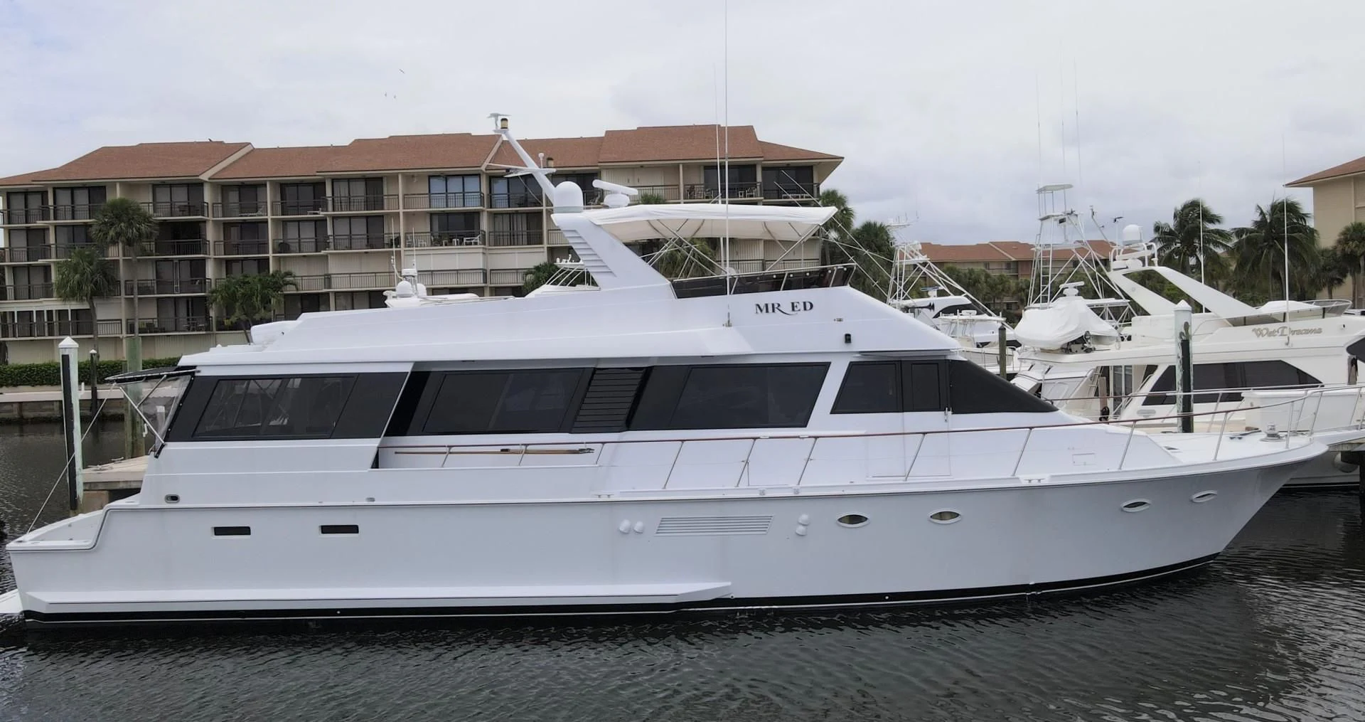 a white yacht on a dock aboard MR. ED Yacht for Sale