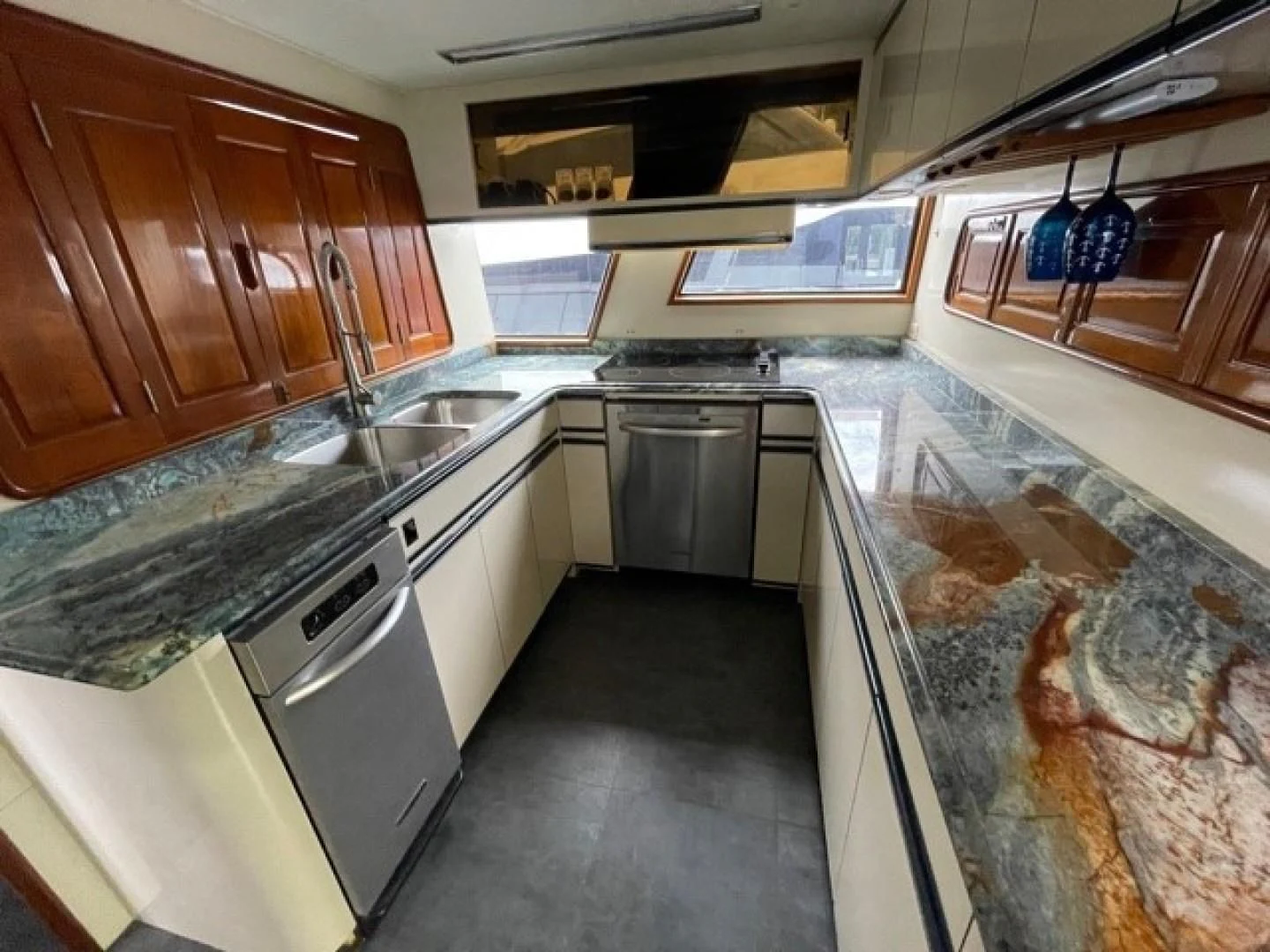 a kitchen with a marble counter top aboard MR. ED Yacht for Sale