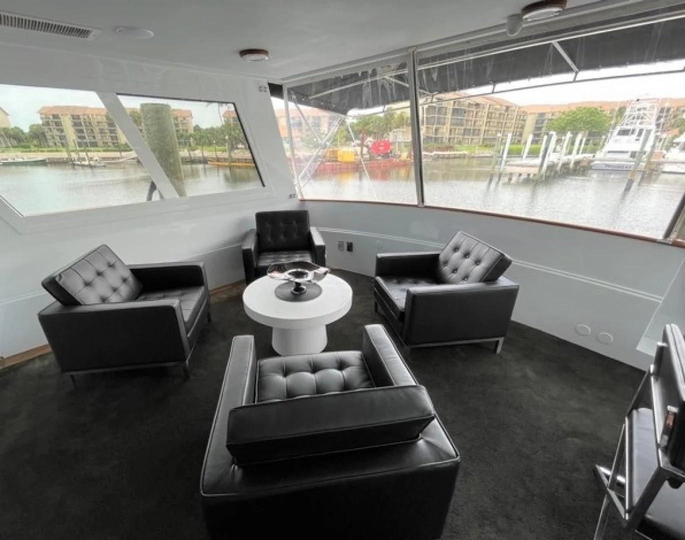 a room with couches and a table aboard MR. ED Yacht for Sale