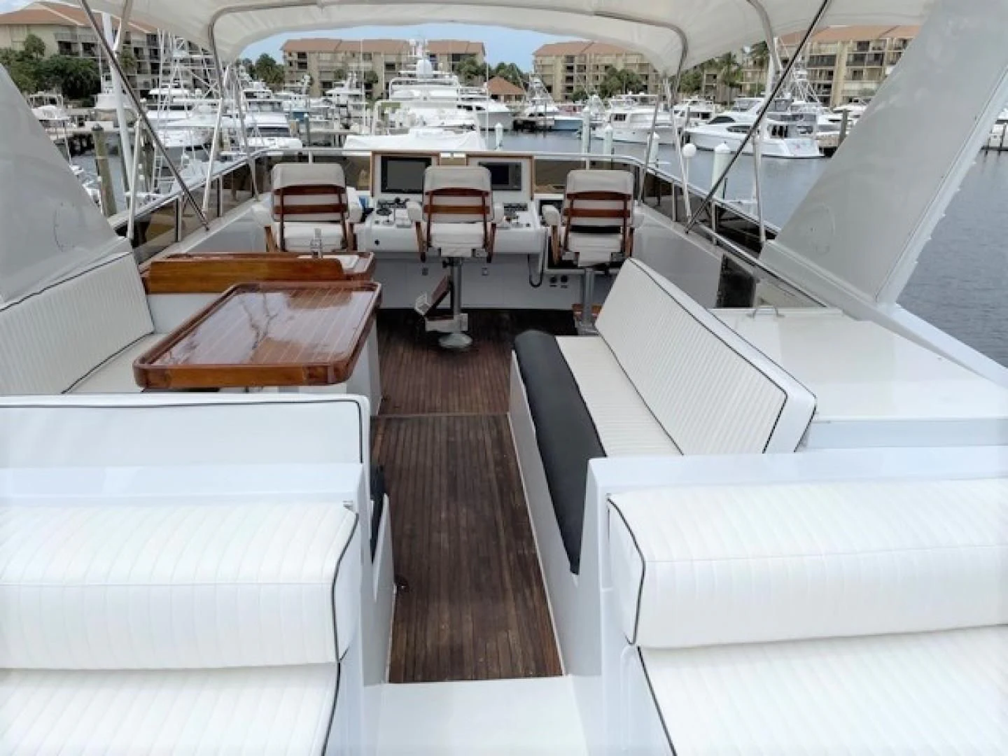 a boat deck with a table and chairs on it aboard MR. ED Yacht for Sale