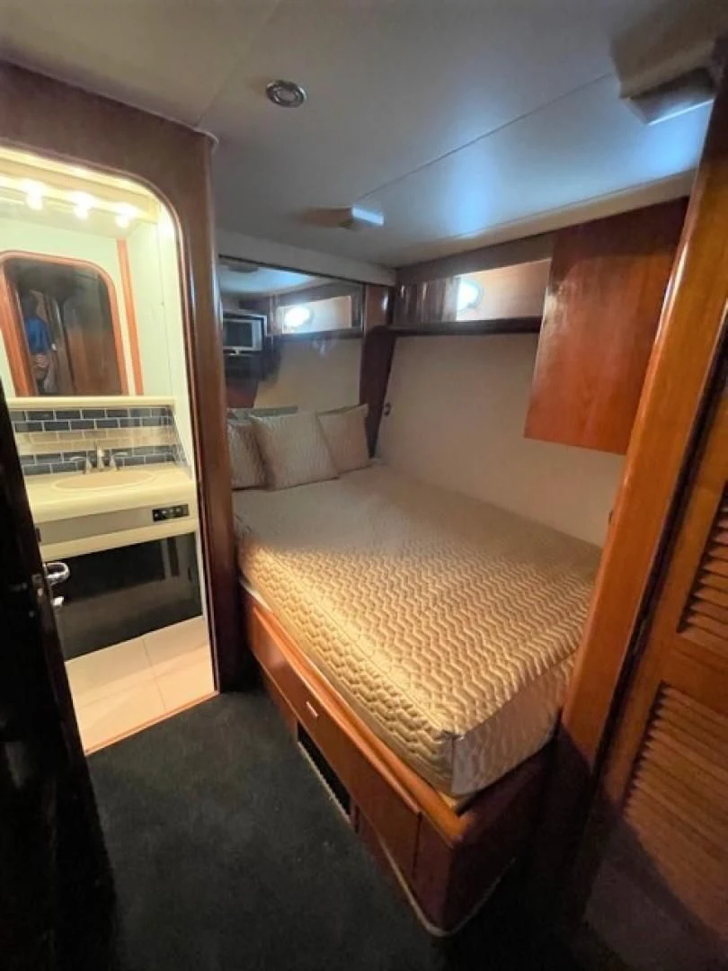 a bed in a room aboard MR. ED Yacht for Sale